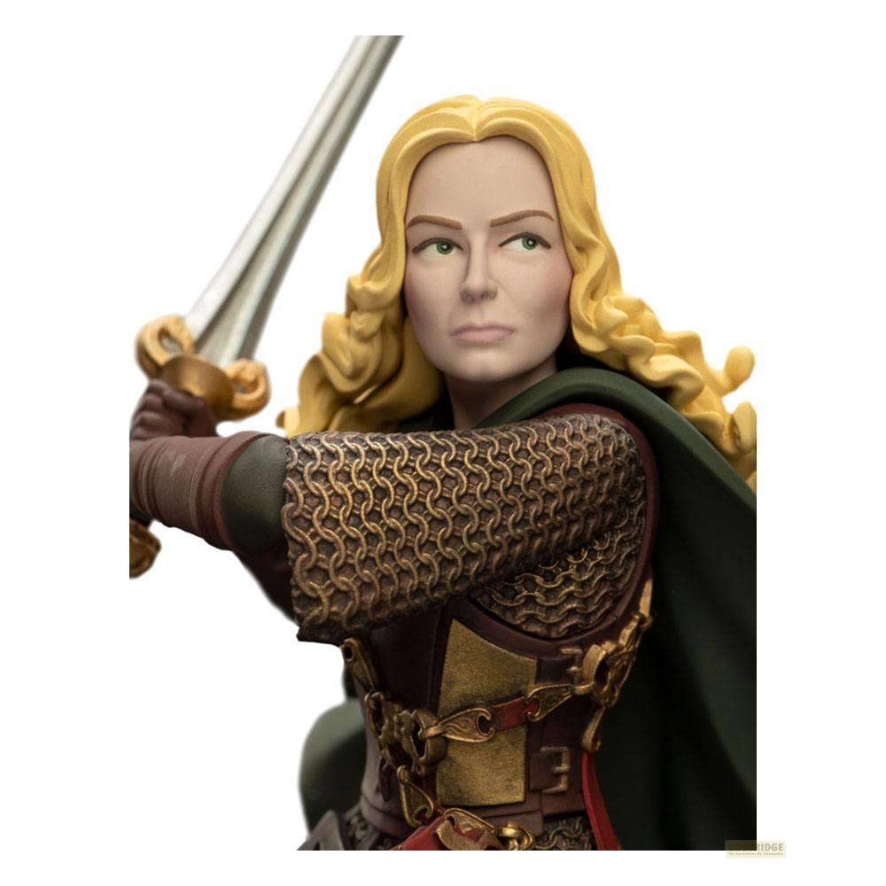 Eine Frau mit blonden Haaren und Rüstung hält ein Schwert.