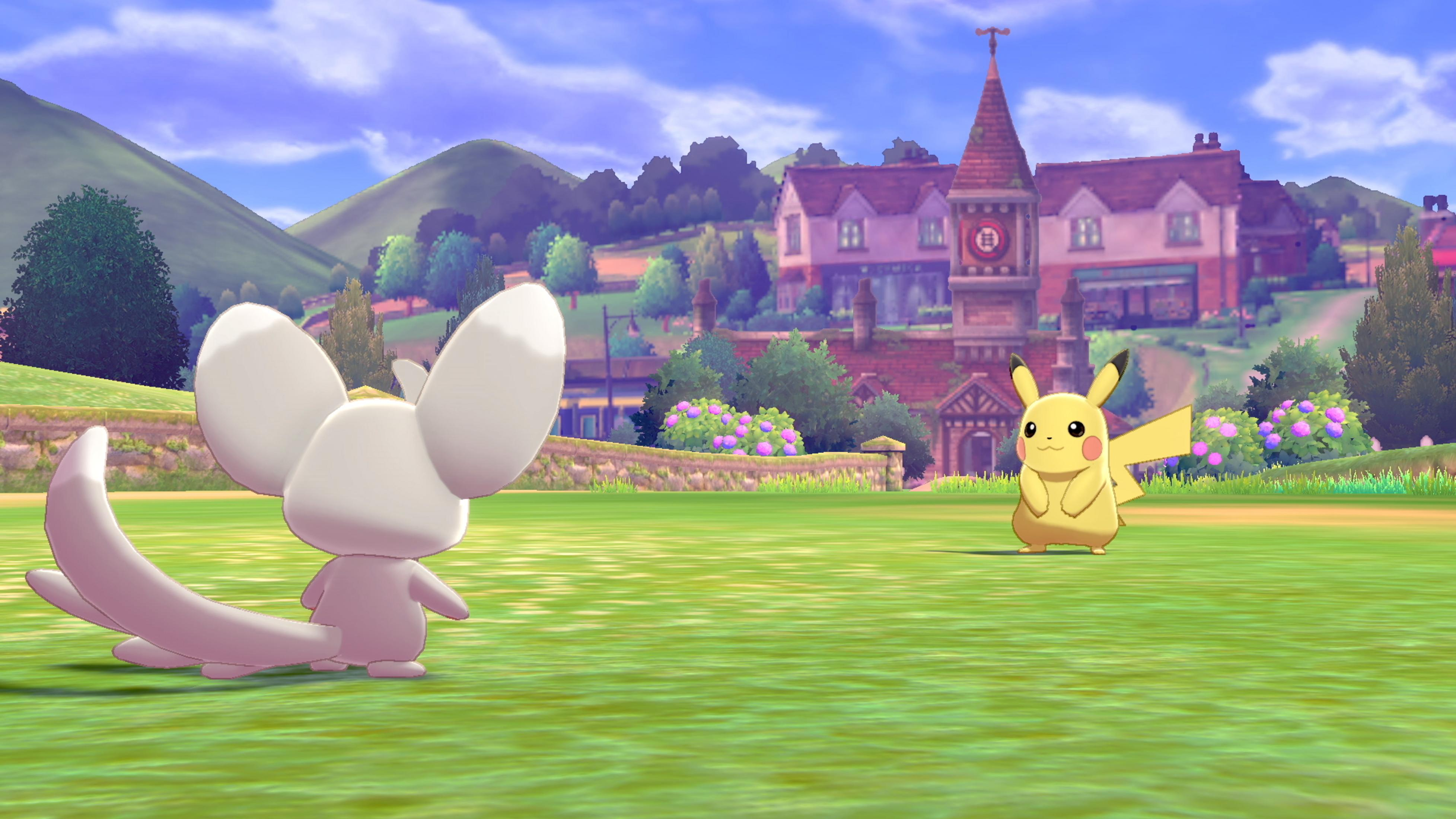 Biały Pokémon z dużymi uszami i długim ogonem stoi na zielonym polu.