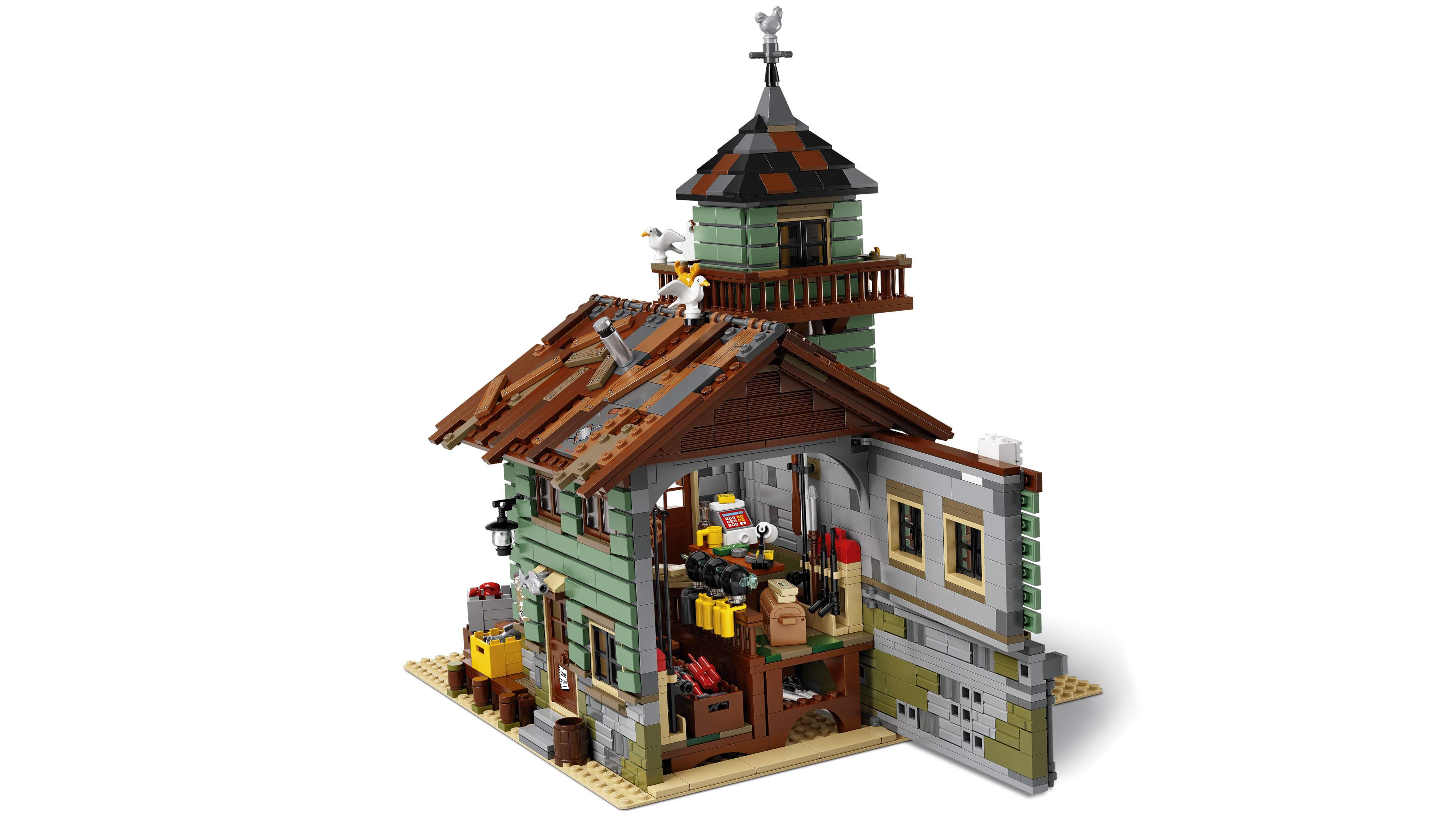 Yeşil duvarlı, ahşap çatılı Lego binası ve rüzgar gülü olan bir kule.