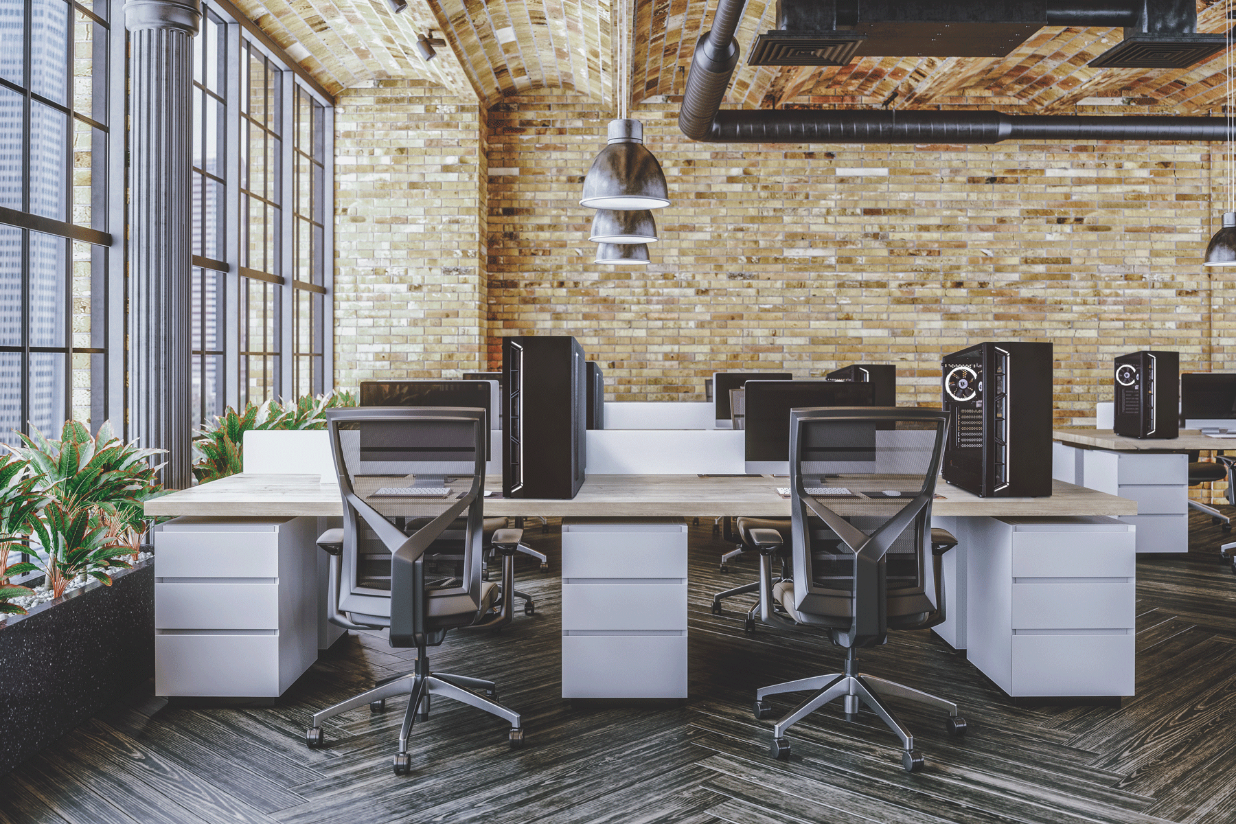 Nowoczesne biuro z biurkami, komputerami i krzesłami. Ceglane ściany.