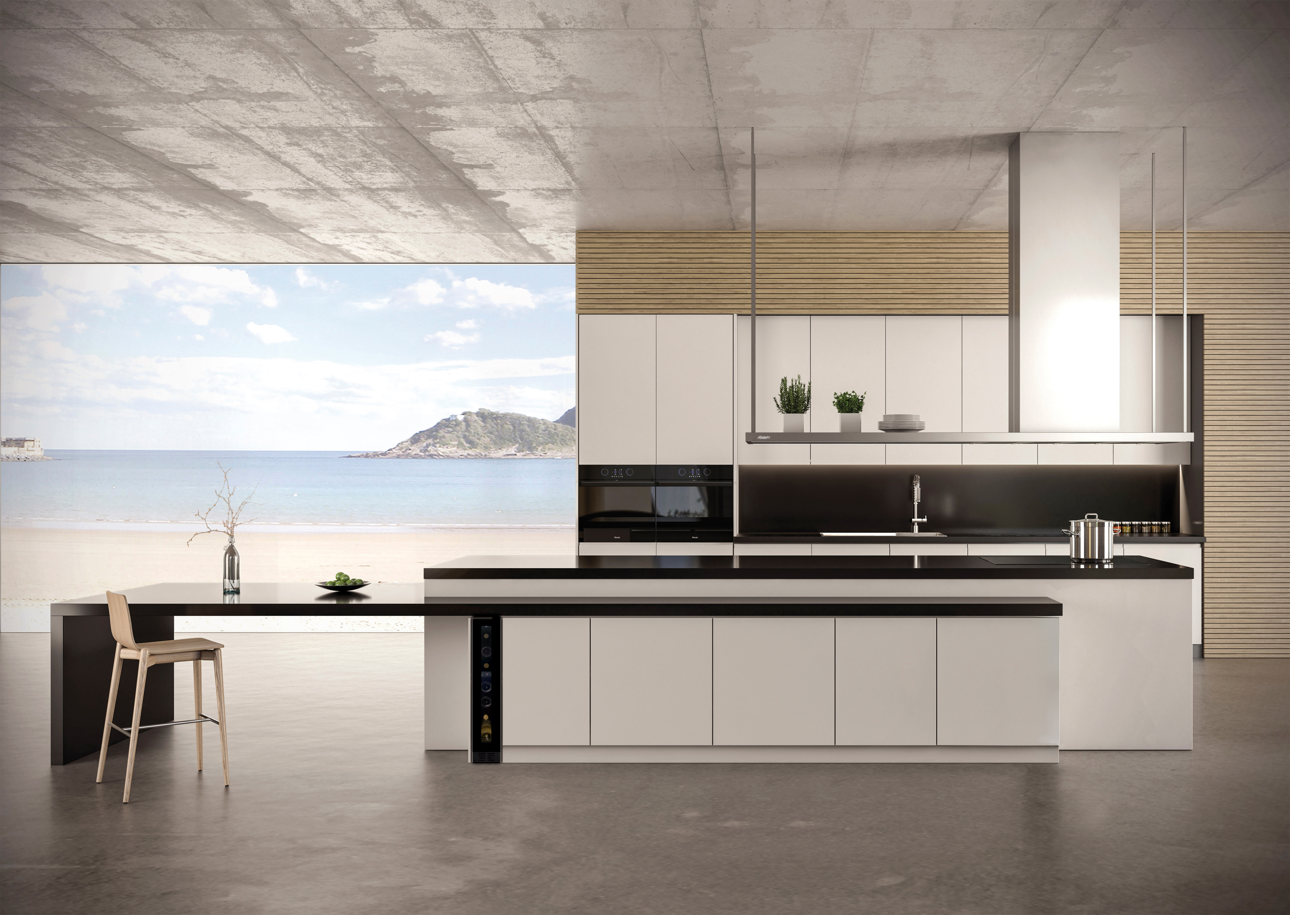 Cocina moderna con vista al mar, isla, taburete y acabado de hormigón.