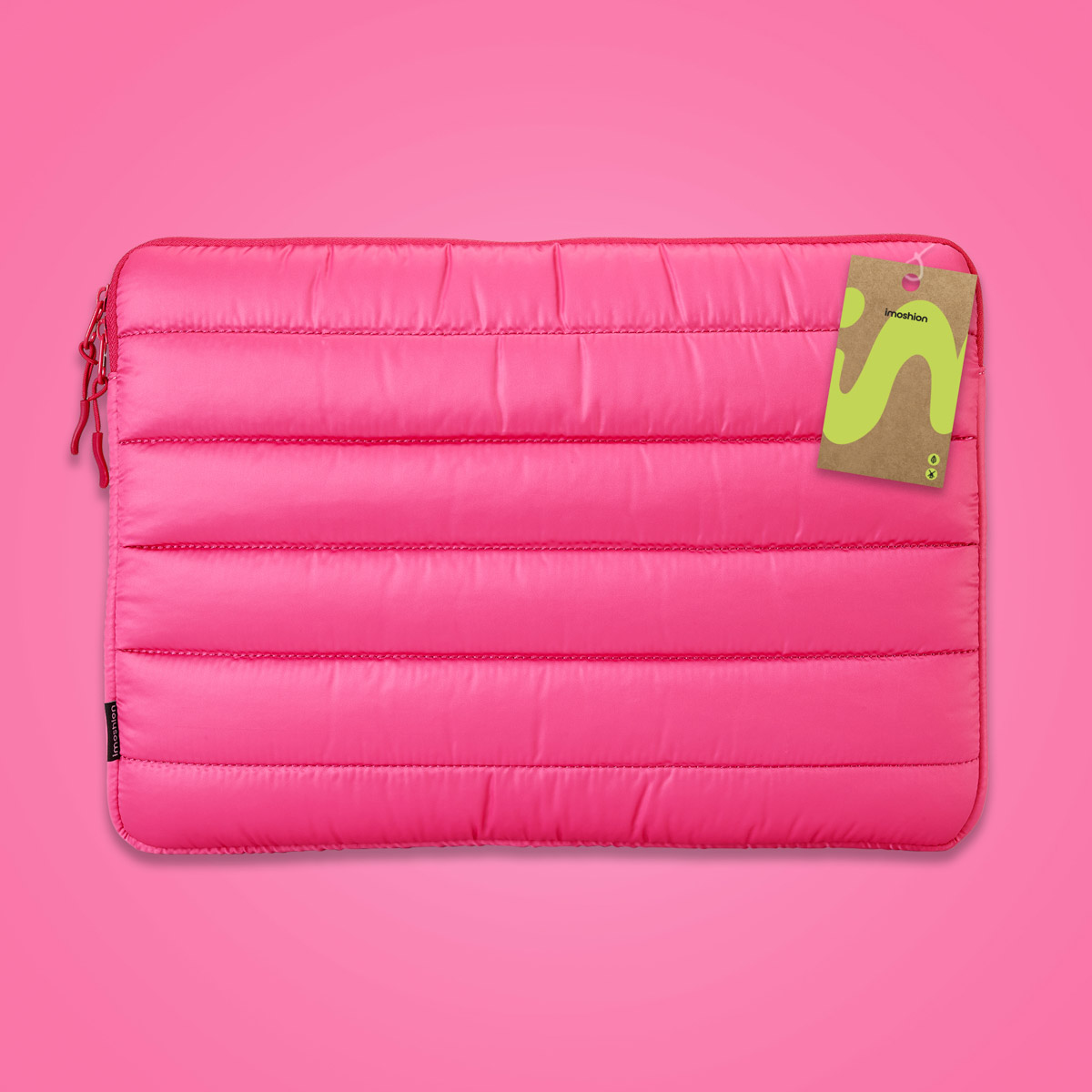 A padded, bright pink laptop sleeve with a zipper and a tag.
