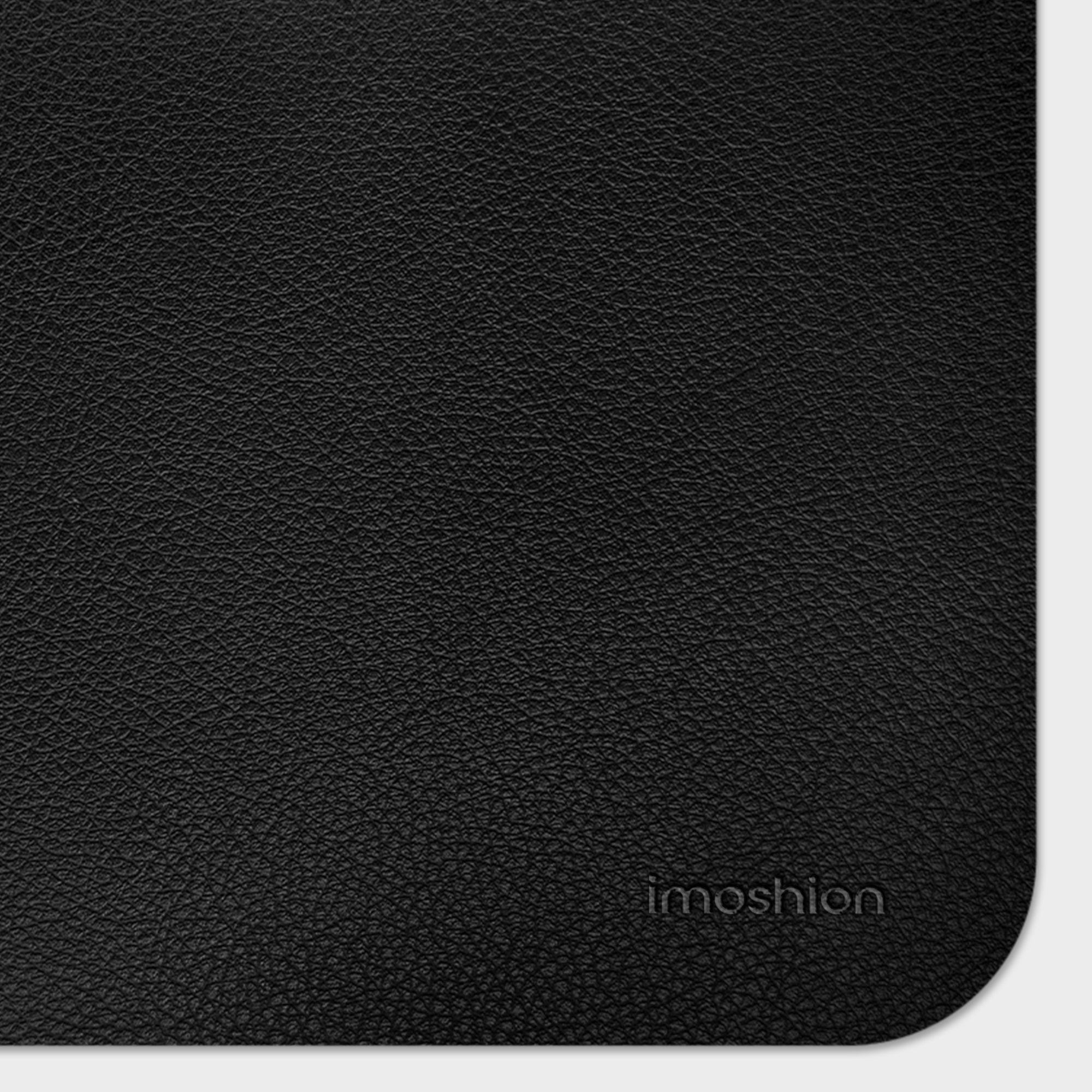 A close-up of black leather with a subtle logo.