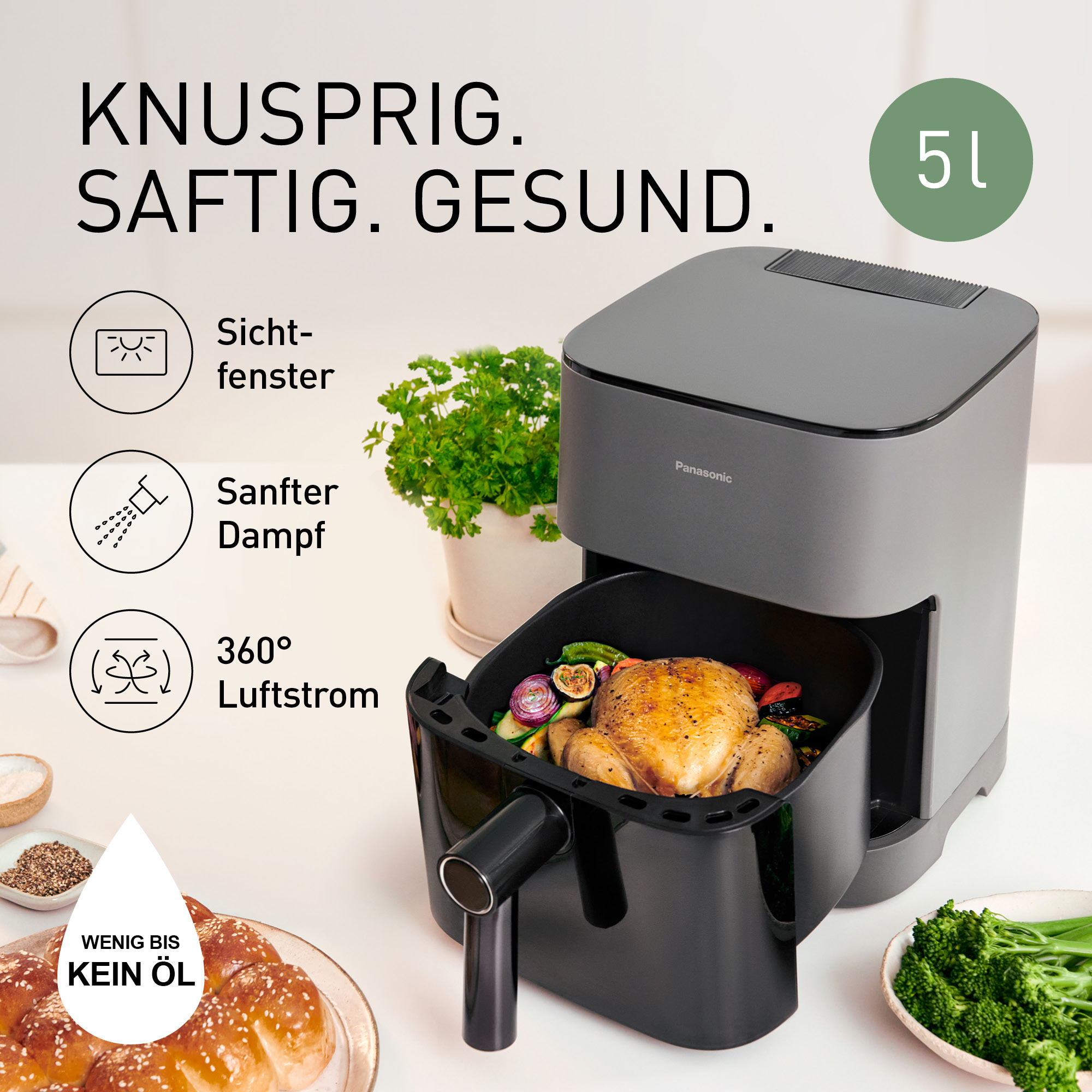 Una freidora de aire Panasonic con pollo, verduras y pan. Capacidad 5L.
