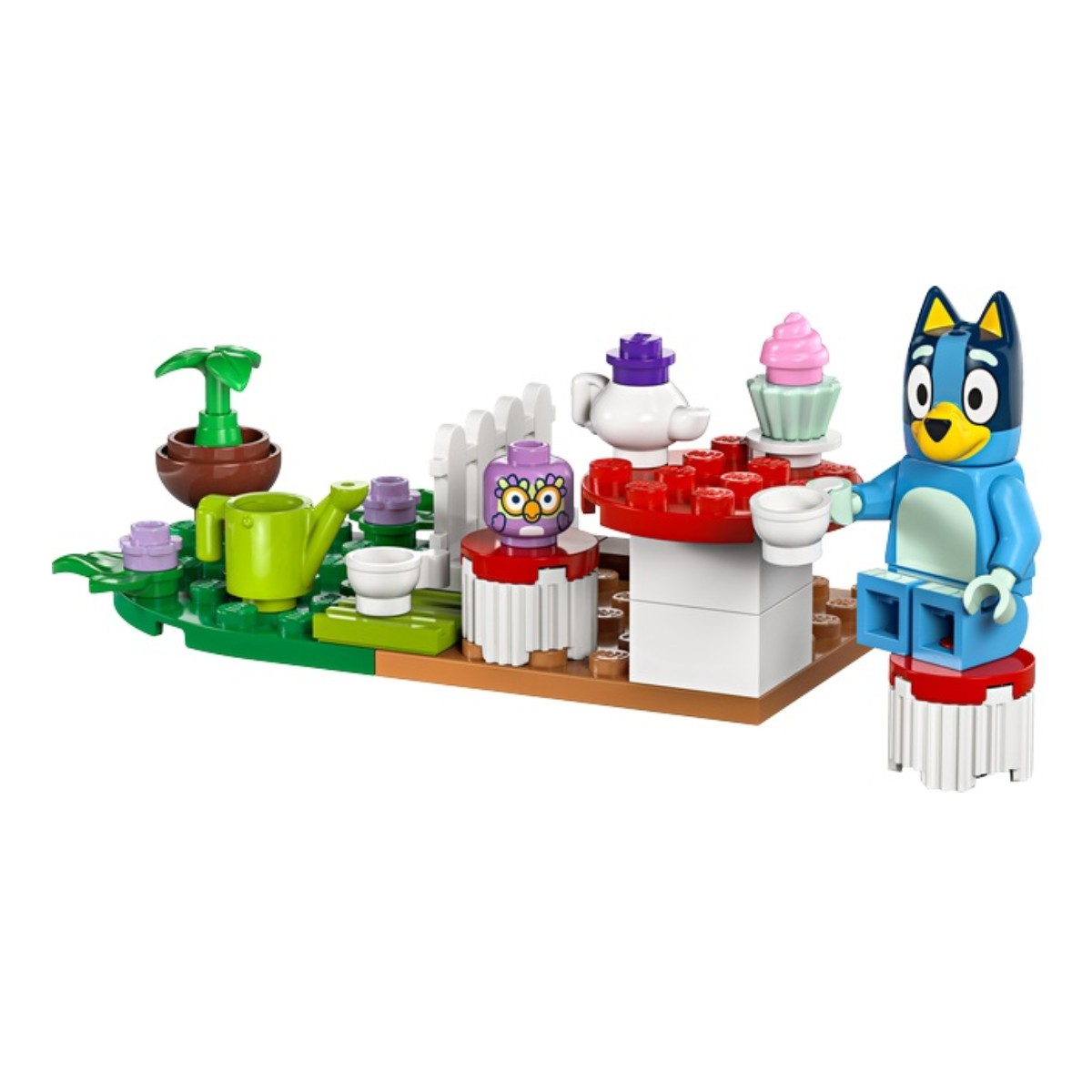 Un set Lego avec une figurine de chien bleu, une table, une théière et une plante.
