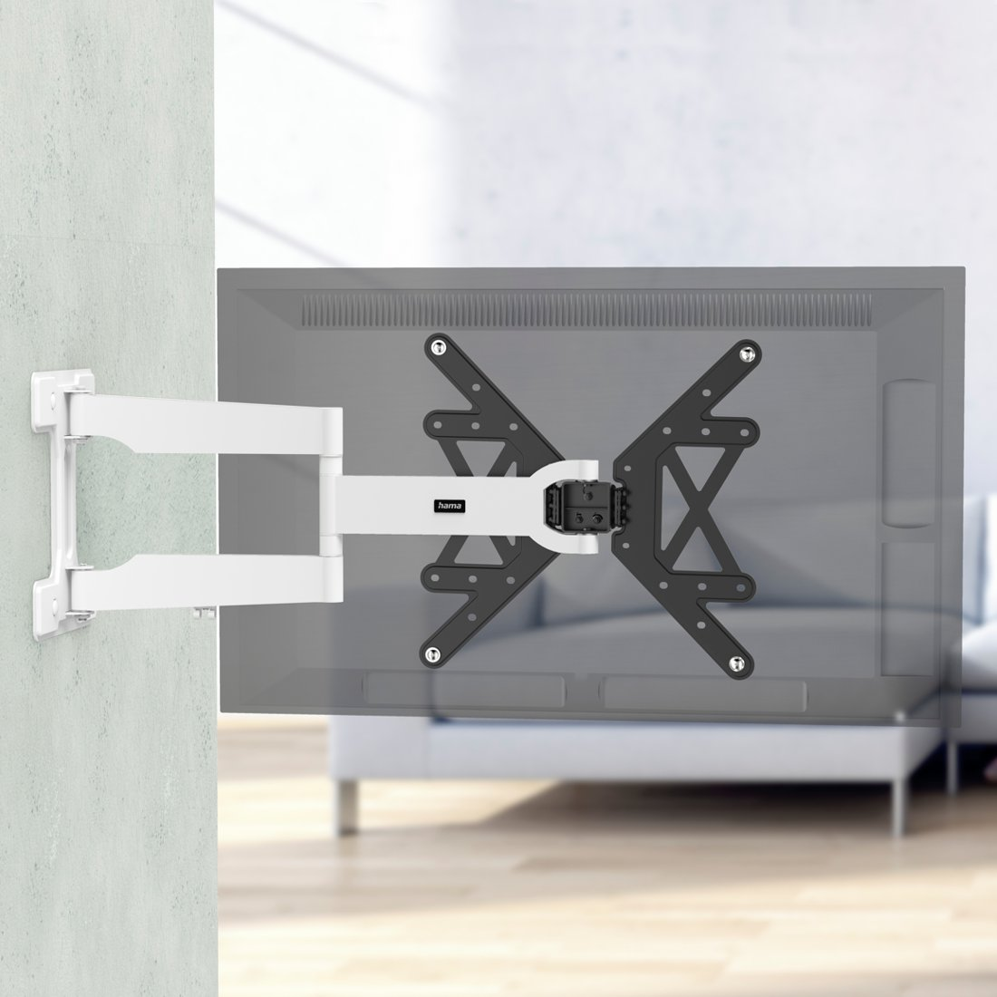 Biały uchwyt ścienny z wysuwanym ramieniem, przymocowany do szarego telewizora.