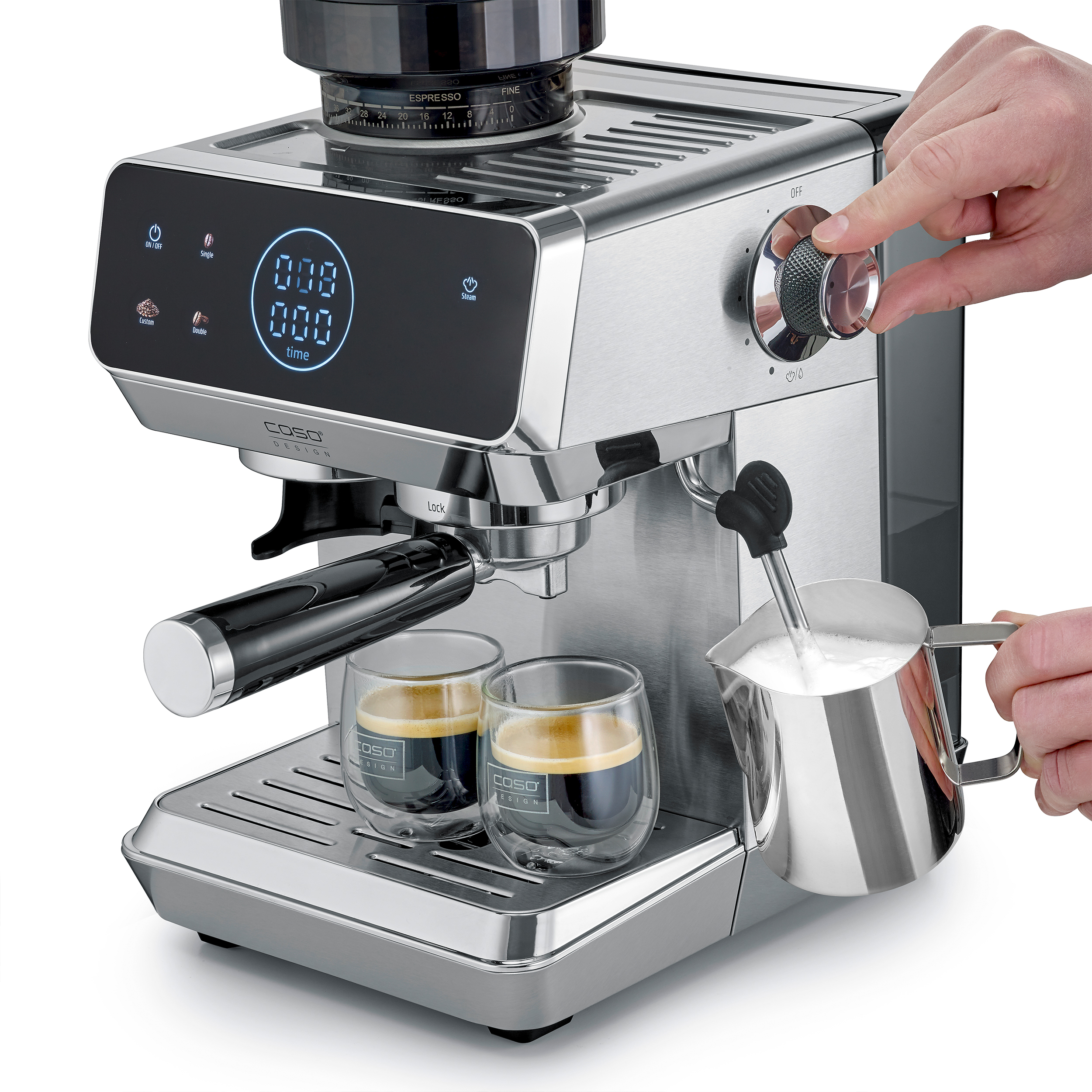 Eine Person benutzt eine Espressomaschine, um Milch aufzuschäumen, während Kaffee in zwei Gläser fließt.