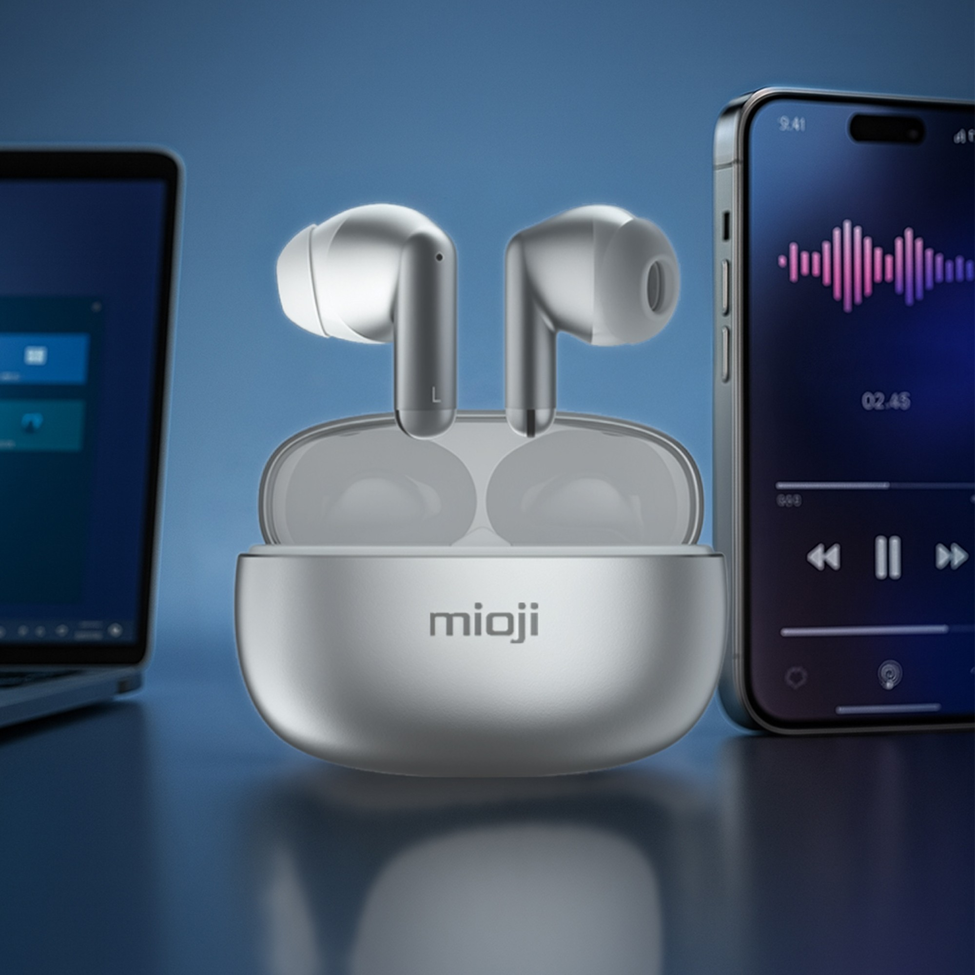 Müzik uygulamalı laptop ve akıllı telefon yanında şarj kutulu gümüş kulaklıklar.