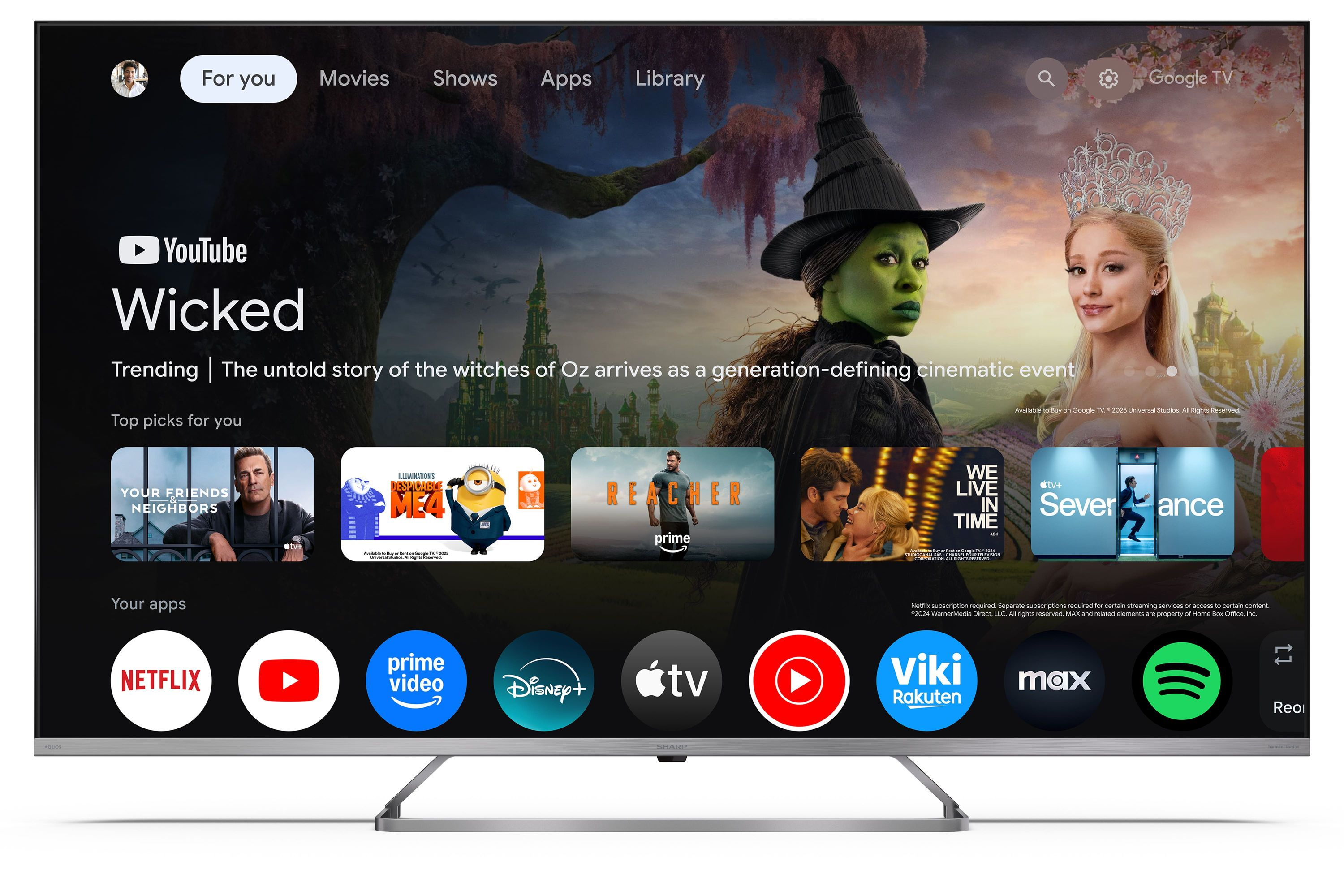 Google TV-Oberfläche zeigt 'Wicked'-Promo mit grüner Hexe und blonder Frau. Apps unten.