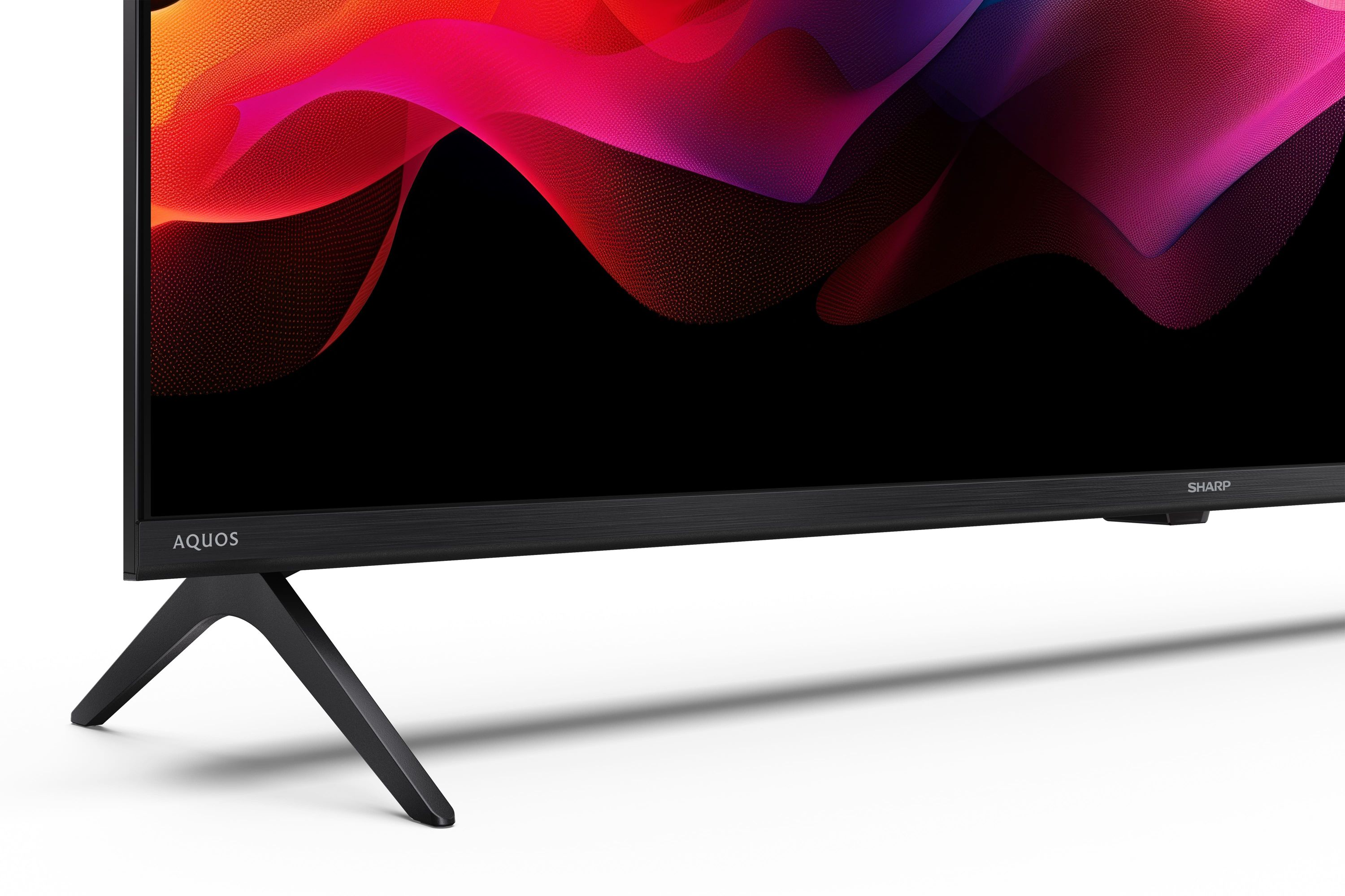 TV nero con supporto moderno e vivace display di sfondo astratto.