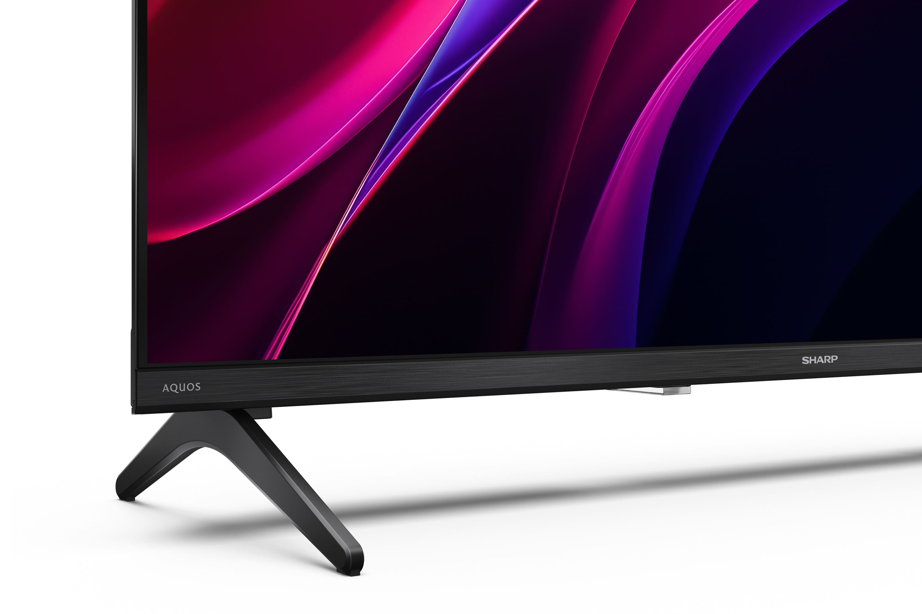 Ein schwarzer Fernseher mit dem Schriftzug AQUOS und SHARP, mit einem bunten abstrakten Muster.