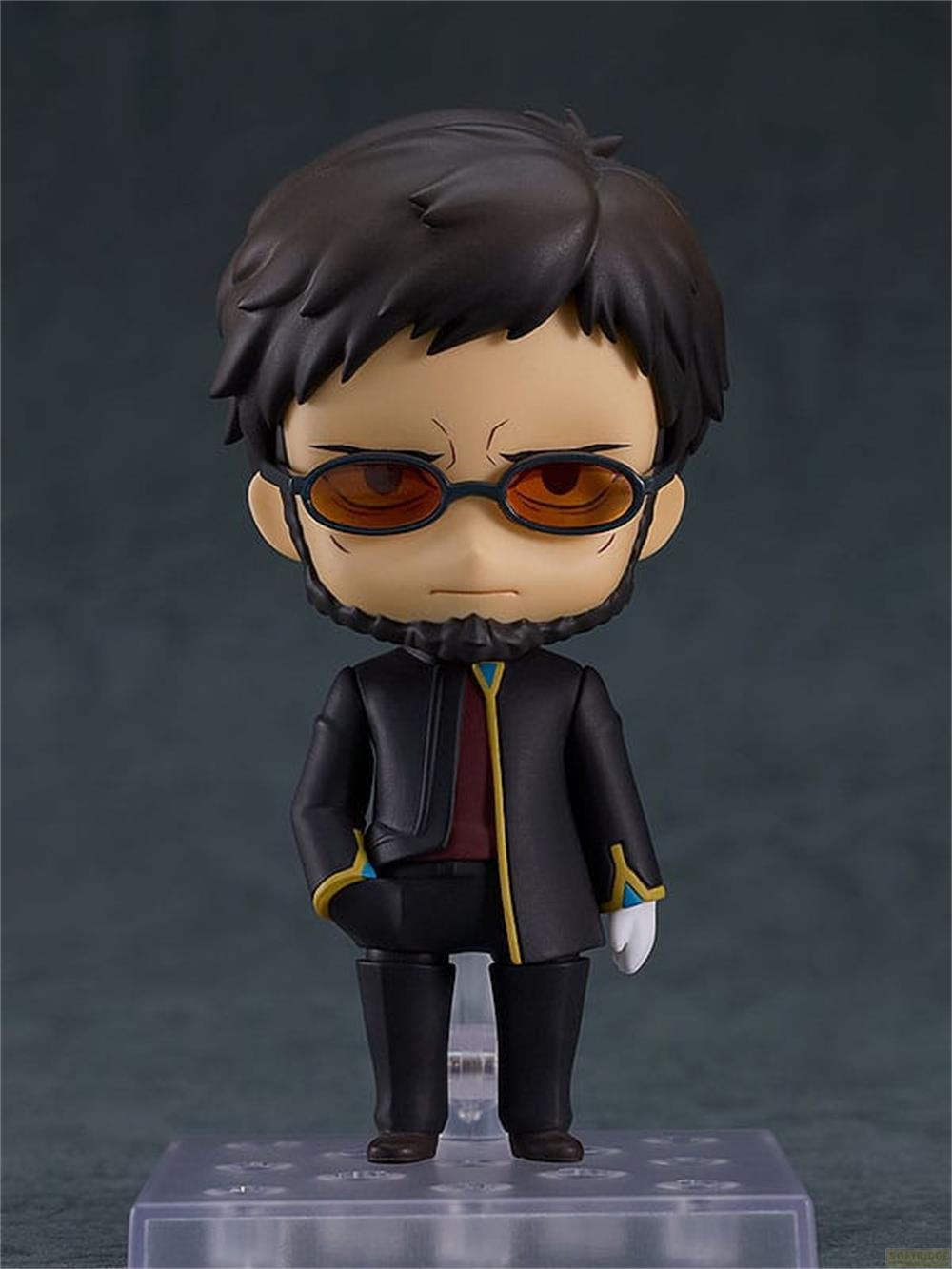 Figura chibi con pelo oscuro, barba, gafas y traje negro.