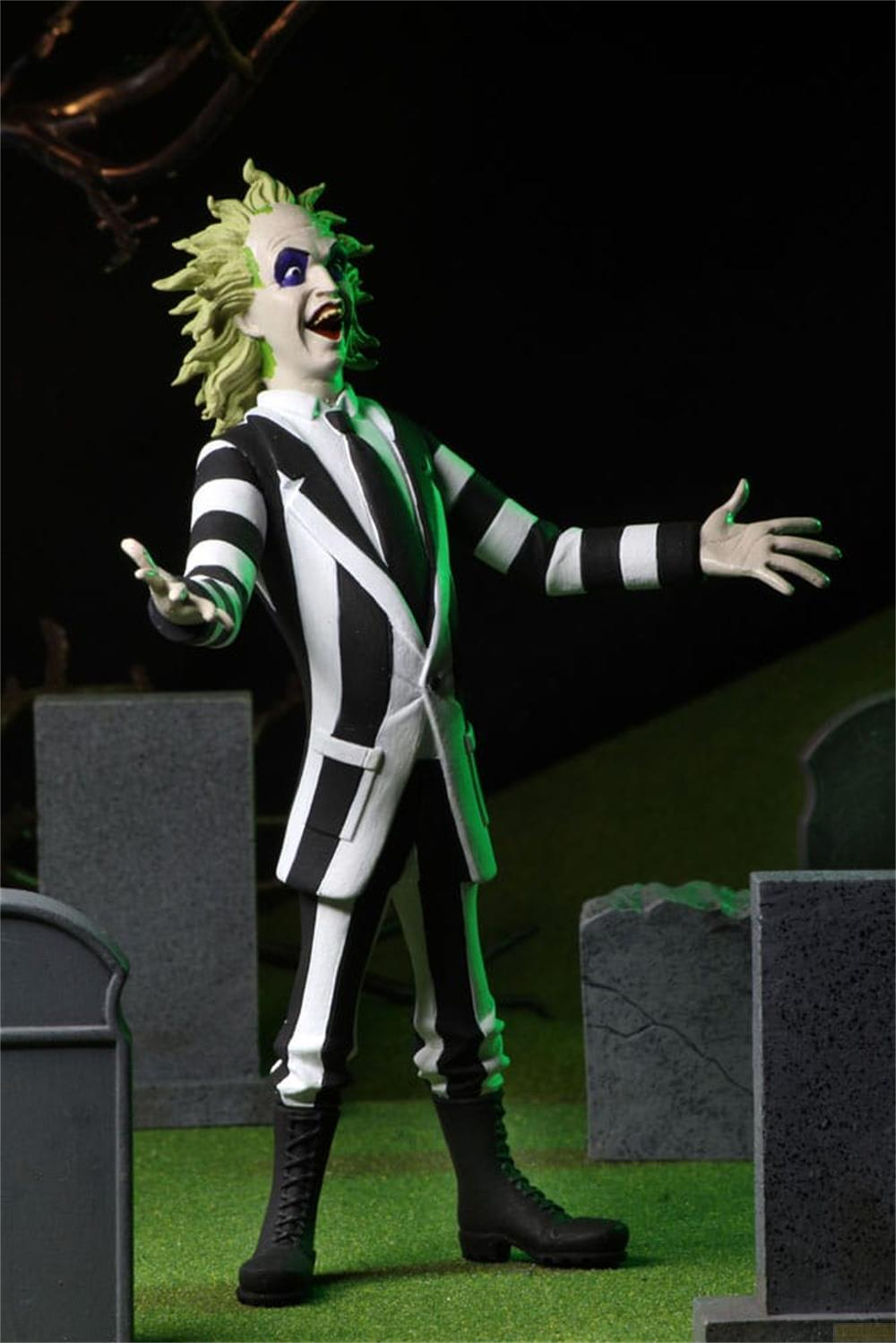 Una figura de Beetlejuice vestida de blanco y negro se para en un cementerio.