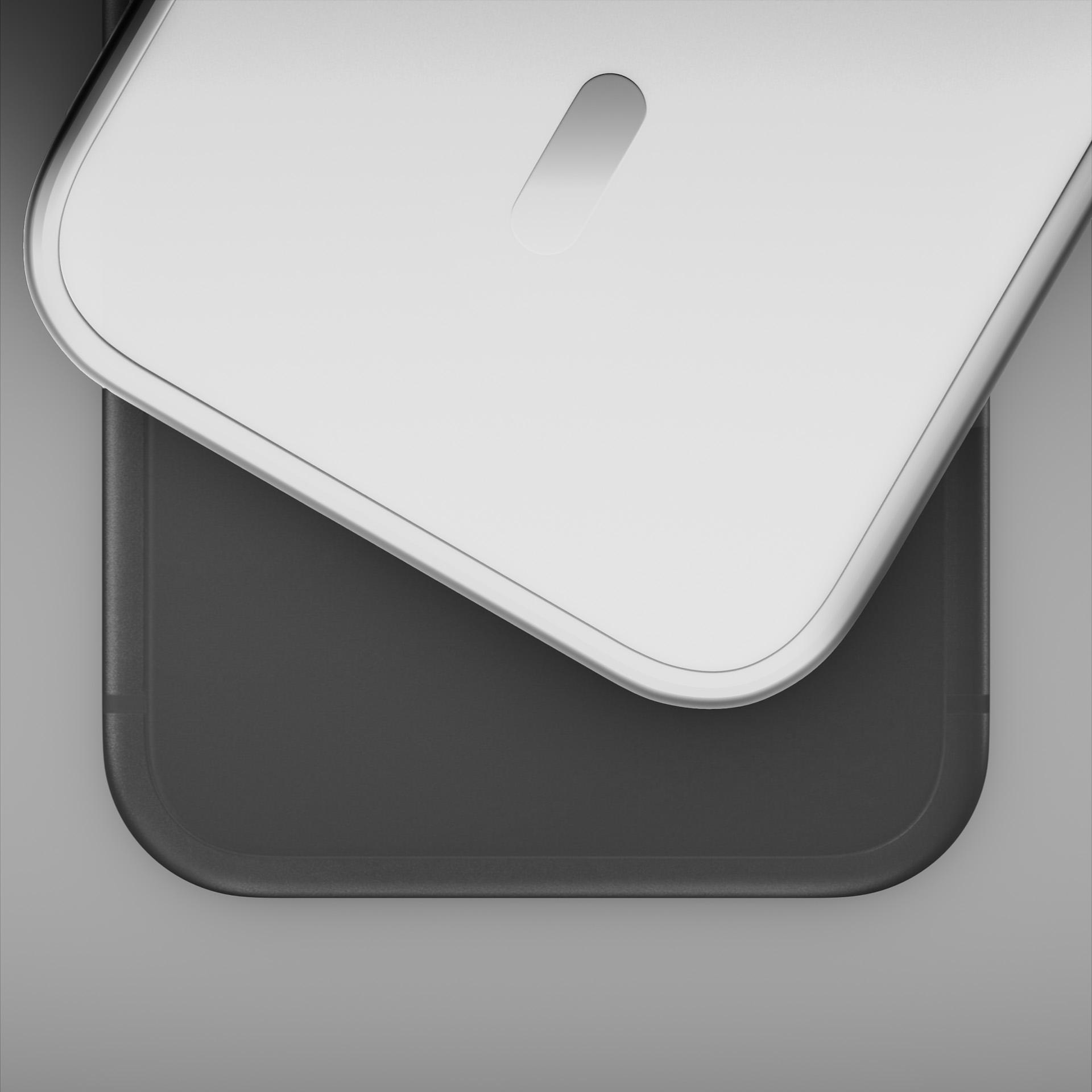 Biała pokrywa z wąskim otworem spoczywa na ciemnym prostokącie.