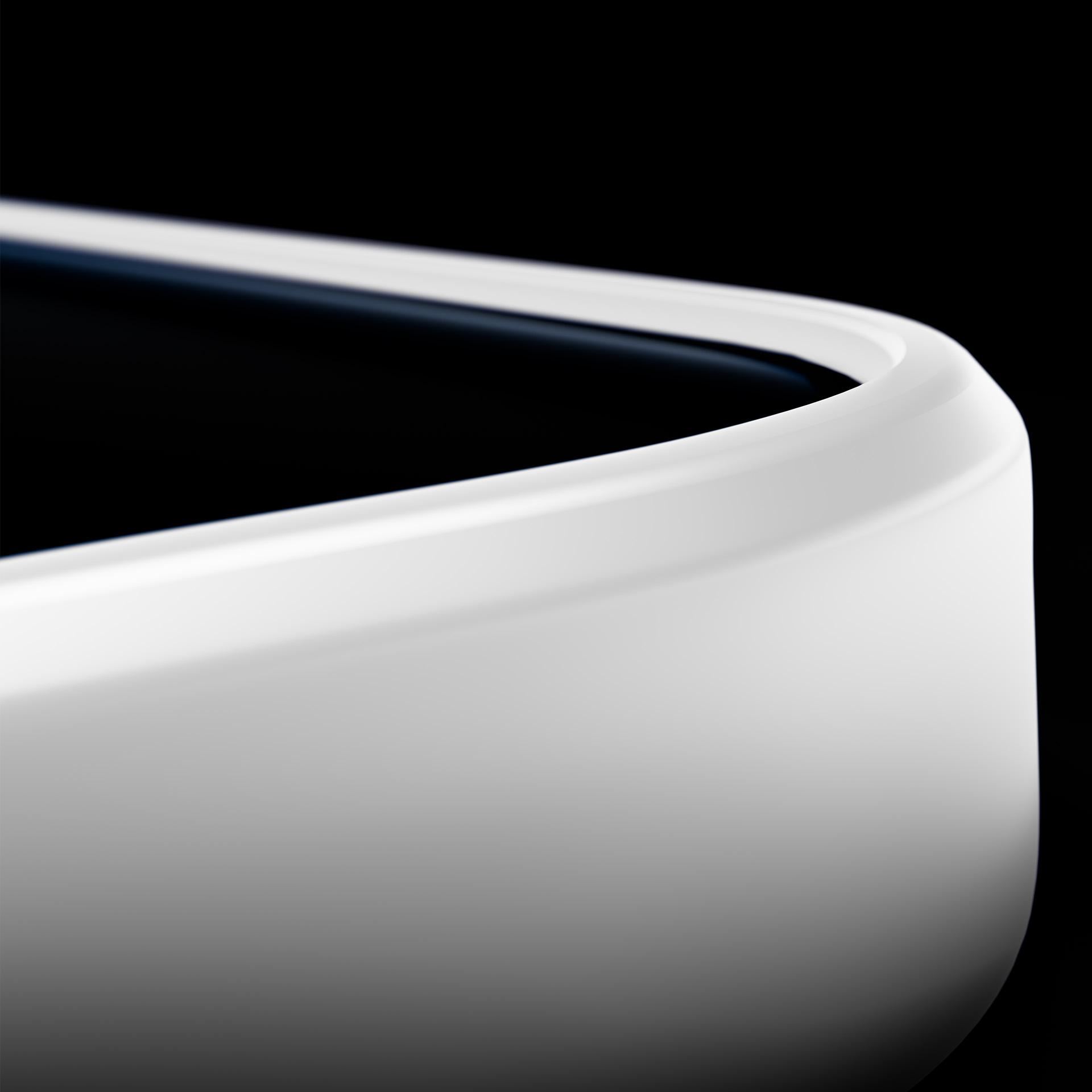 Zbliżenie białej, zakrzywionej krawędzi na ciemnym tle.