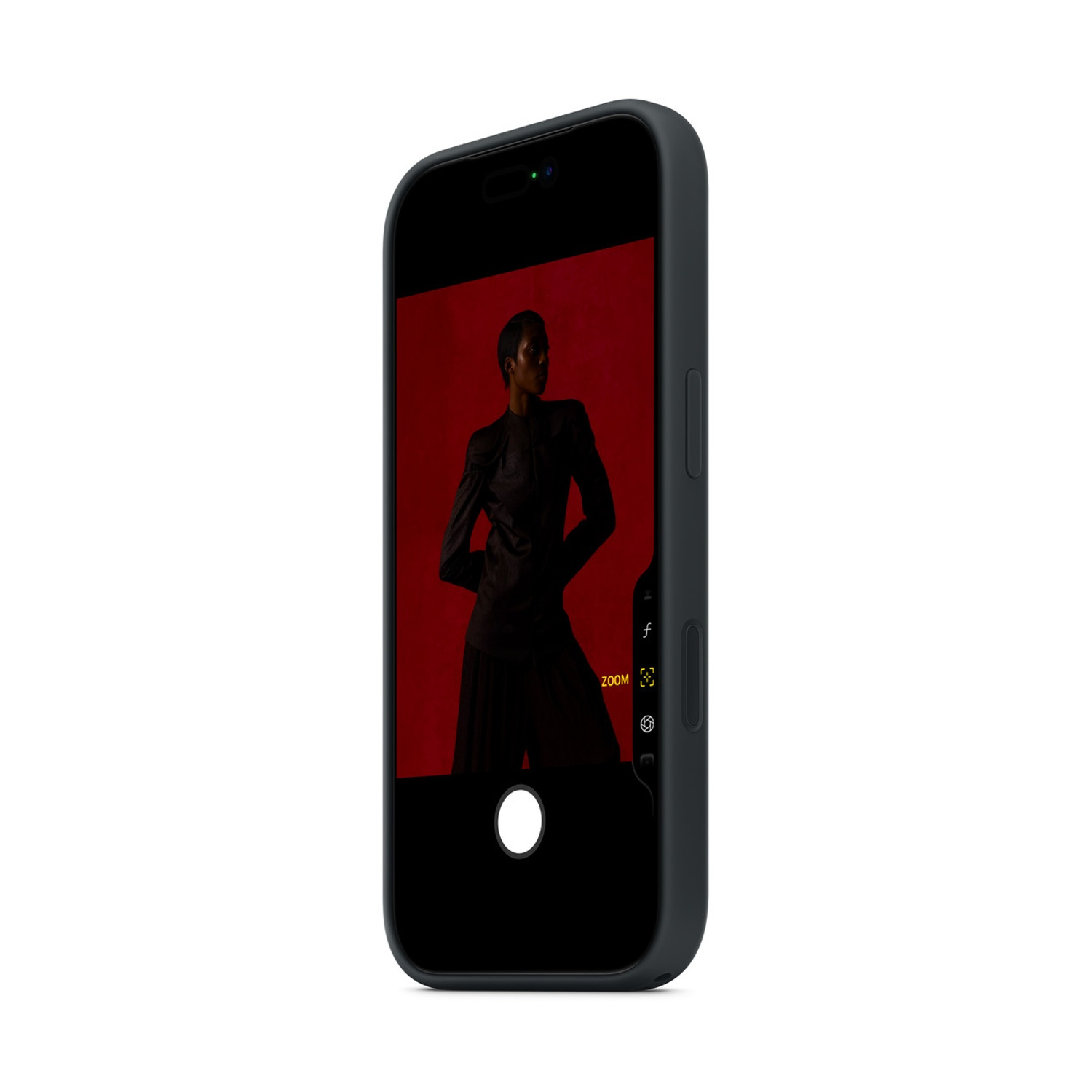 A dark smartphone displays a model in black attire against a red backdrop.