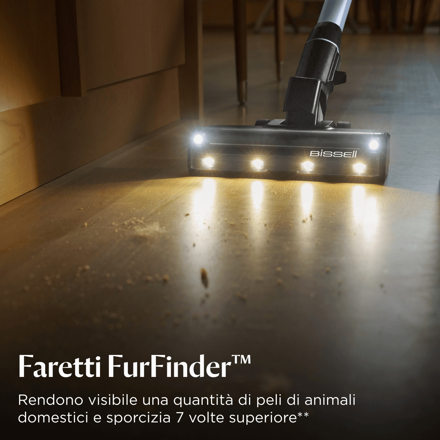 Bissell vacuum brush with lights cleans wood floor with debris.