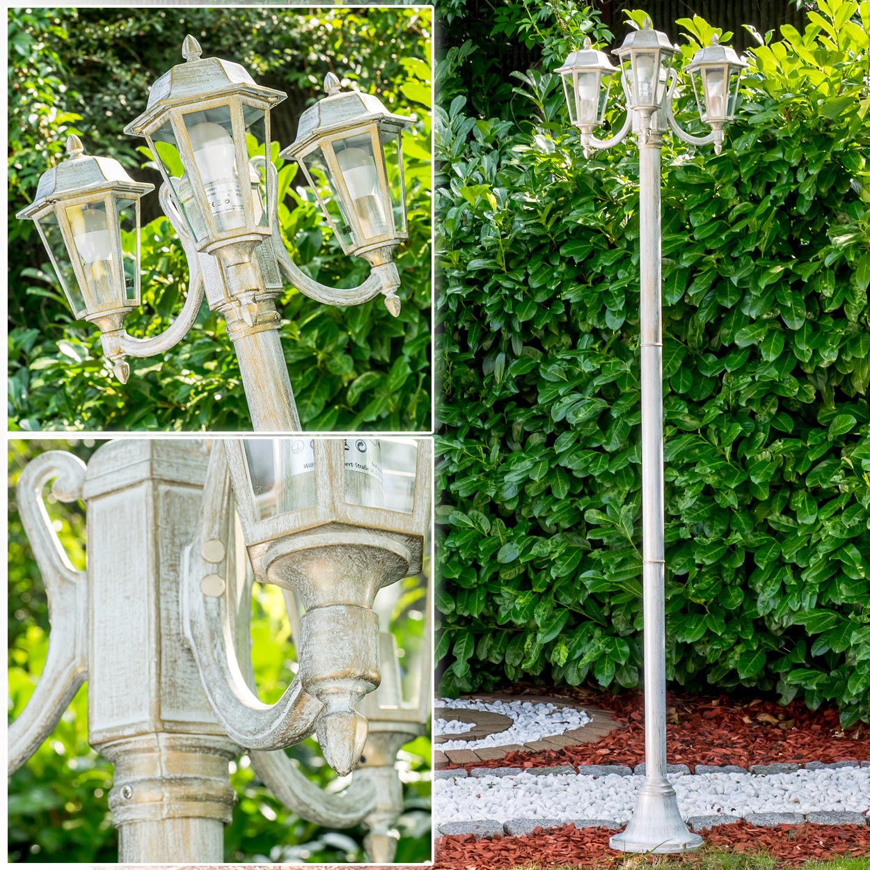 Eine weiße Laterne mit drei Lampen steht im Garten vor einer Hecke.