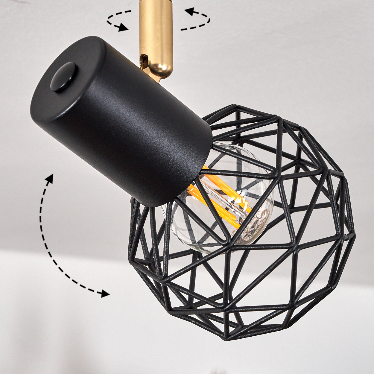 Eine moderne schwarze Lampe mit Drahtkäfig und sichtbarer Glühbirne, die auf einer Decke montiert ist.