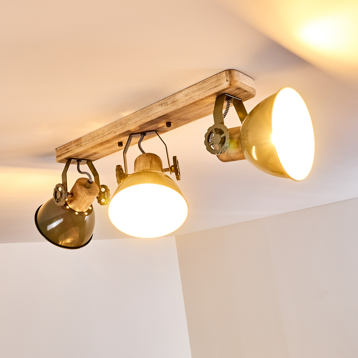 Deckenleuchte mit Holzsockel und drei verstellbaren Lampenschirmen in Gold und Olivgrün.