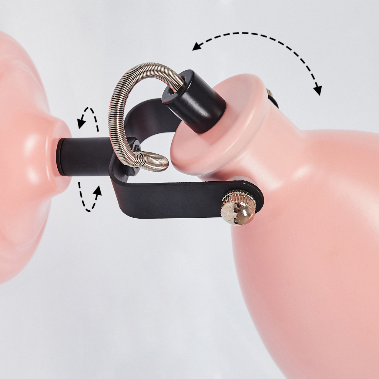 Ein pinker Lampenarm mit schwarzen Gelenken und Federn, die die Bewegung anzeigen.