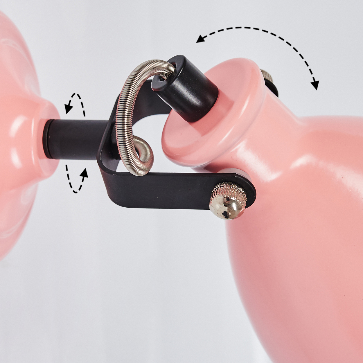 Nahaufnahme eines rosa Lampenarms mit schwarz-metallischen Gelenken und Federn.