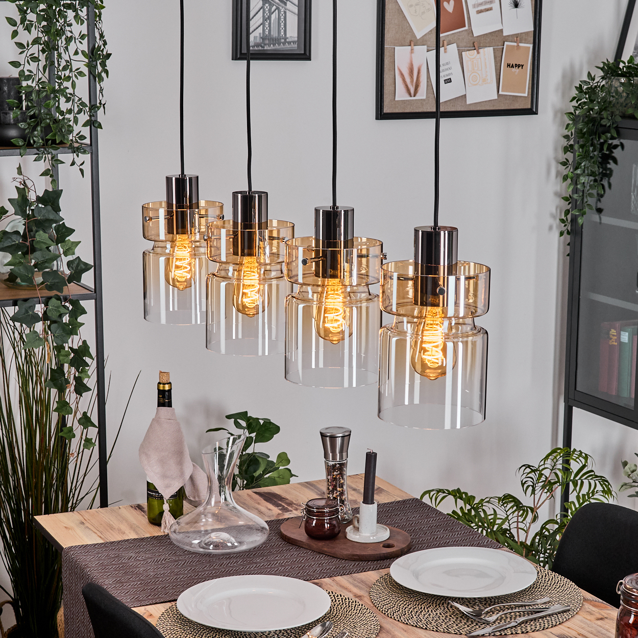 Ein Holztisch mit gedeckter Tafel und fünf Hängeleuchten darüber.