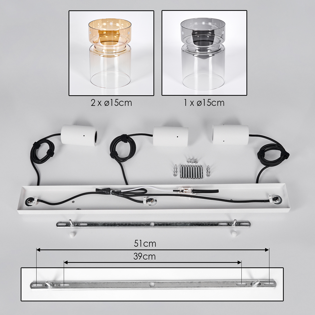Lampenteile: zwei bernsteinfarbene und ein graues Glas, weiße Leuchten, Kabel, Schrauben und Montageplatte.