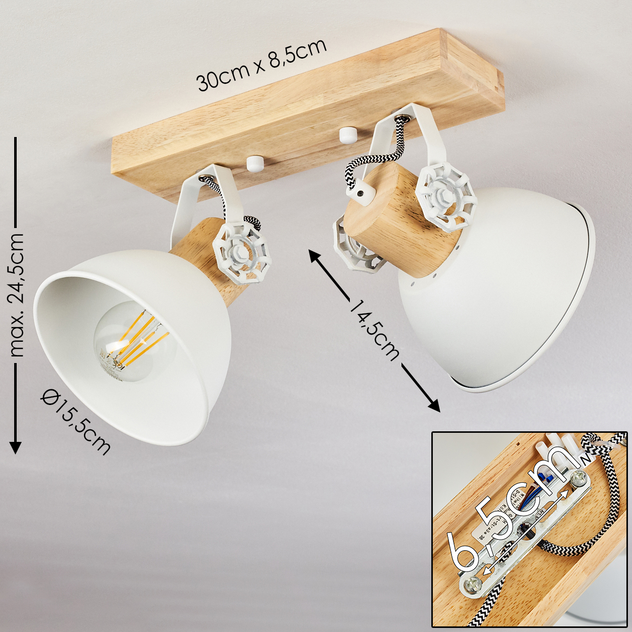 Holzsockel mit zwei weißen, verstellbaren Strahlern, Glühfaden sichtbar.