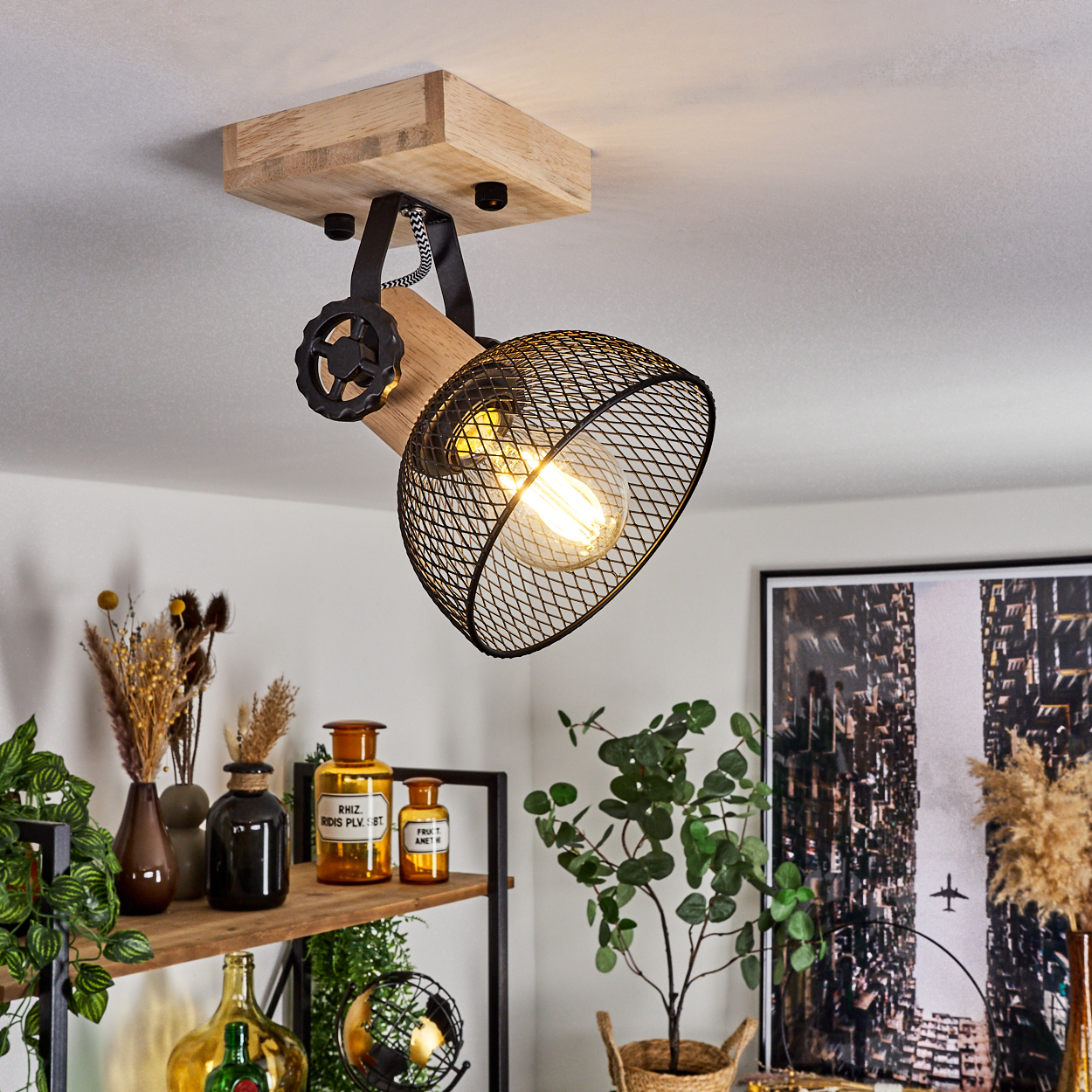 Industrielle Deckenleuchte mit Holzsockel, schwarzem Metallkäfig und Glühbirne.