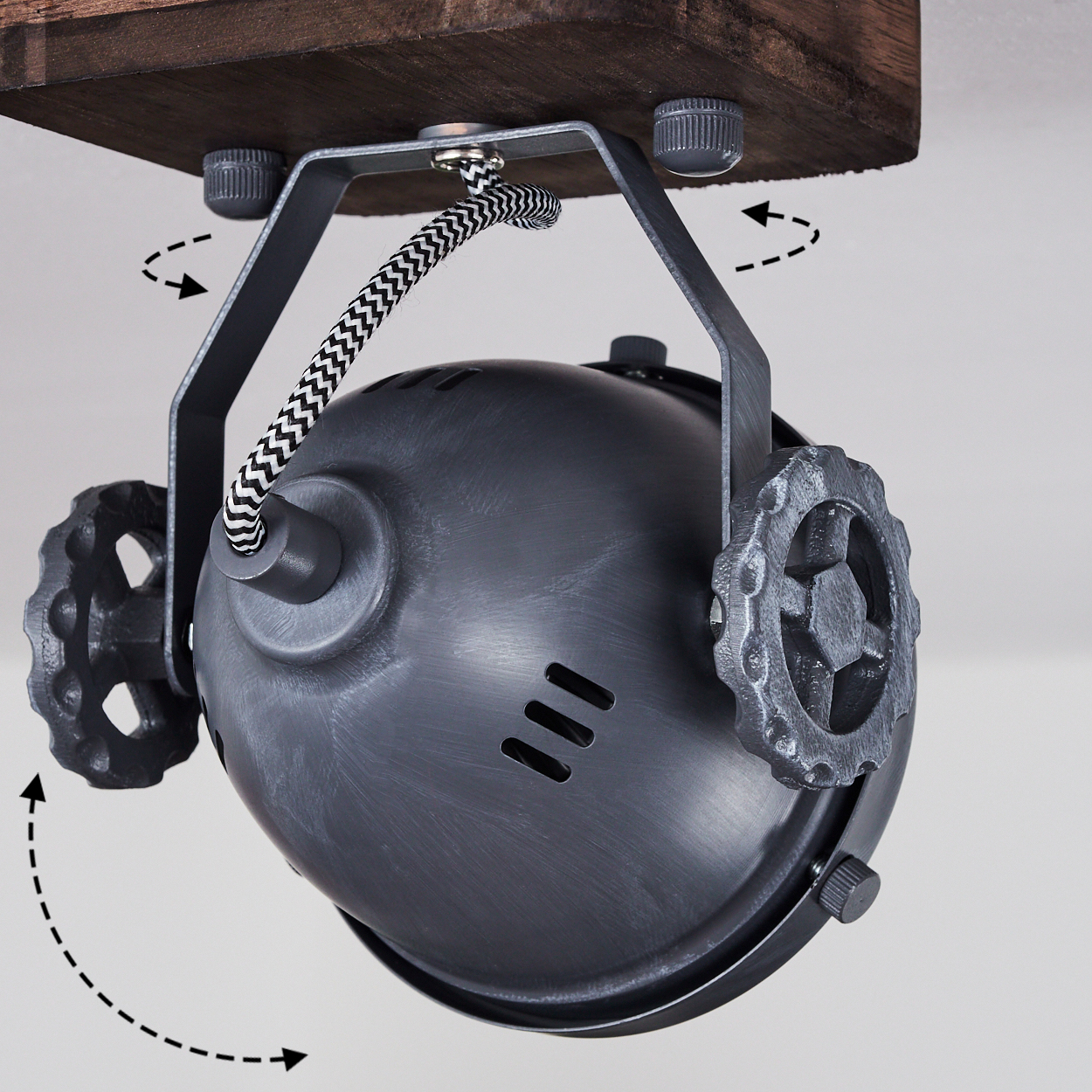 Grauer Strahler mit Zahnrad-Details, befestigt an Holz, mit Kabeln.
