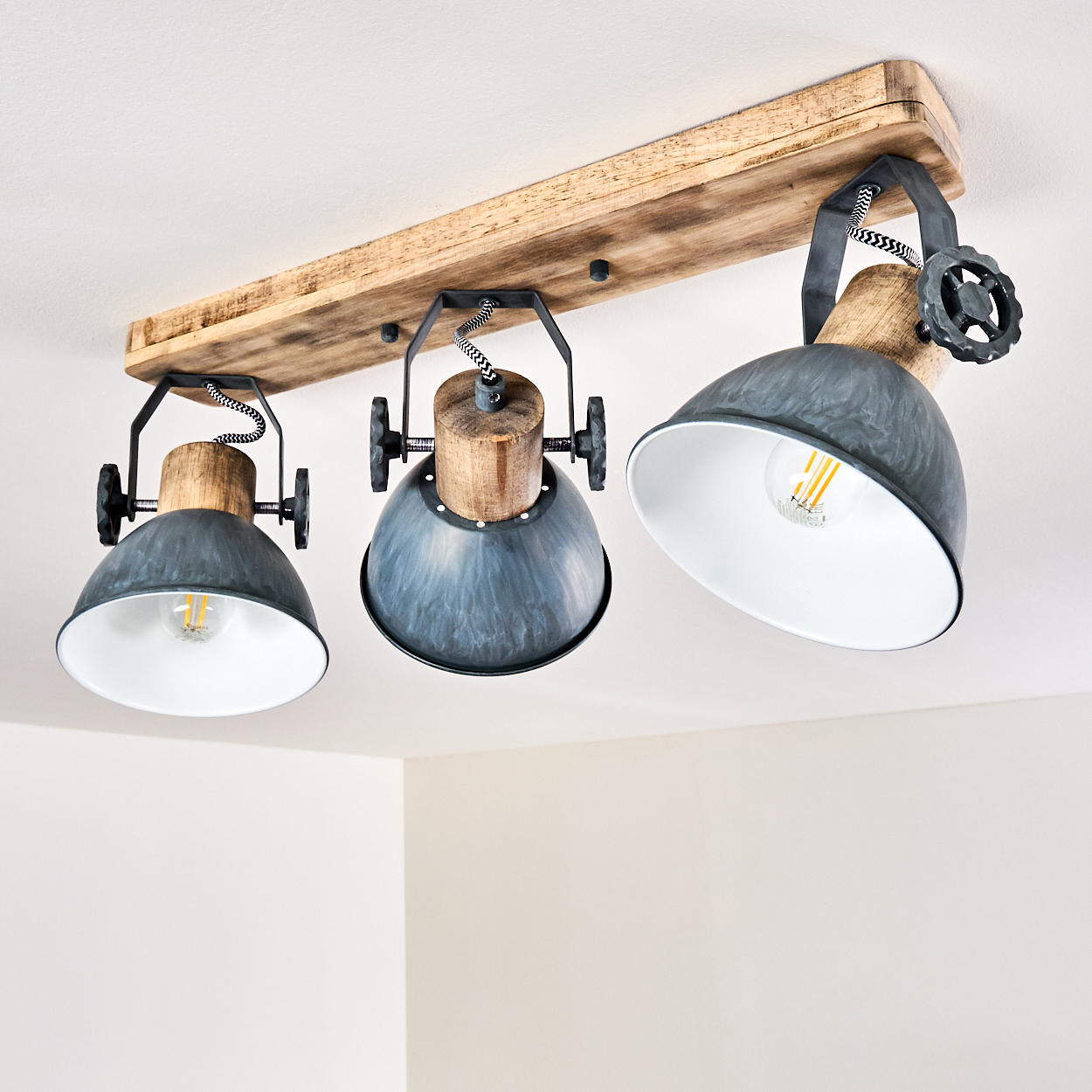 Deckenleuchte mit drei grauen Schirmen, Holz und schwarzen Akzenten.