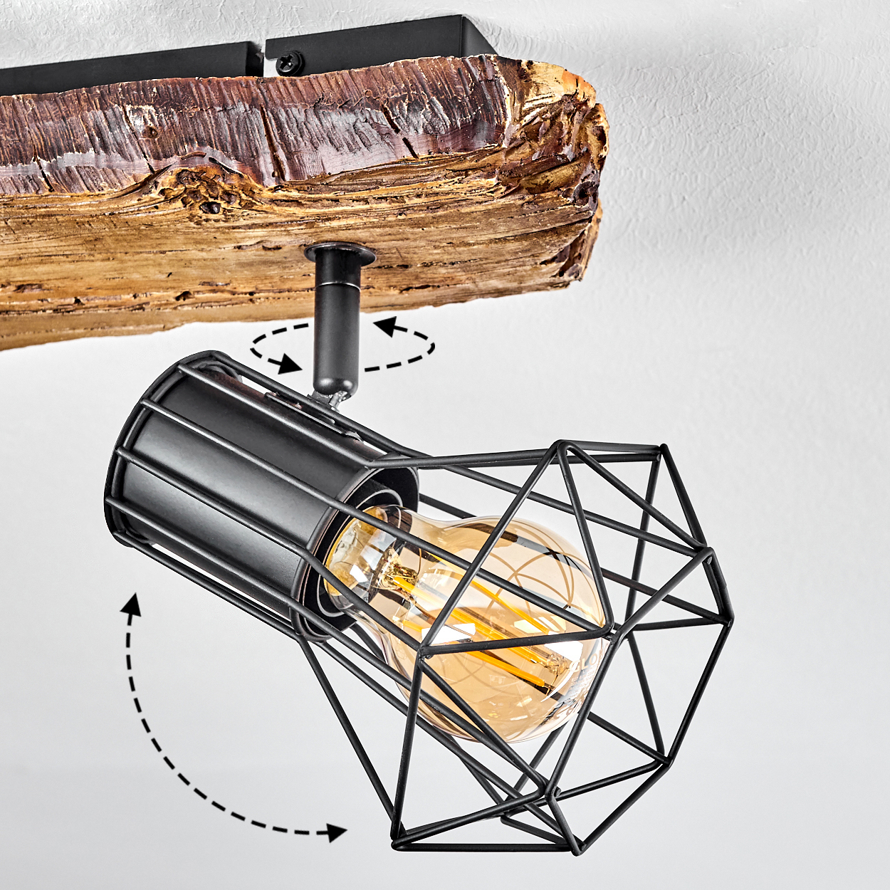 Eine Lampe mit schwarzem Drahtkäfig und Glühbirne hängt an einem Holzträger.