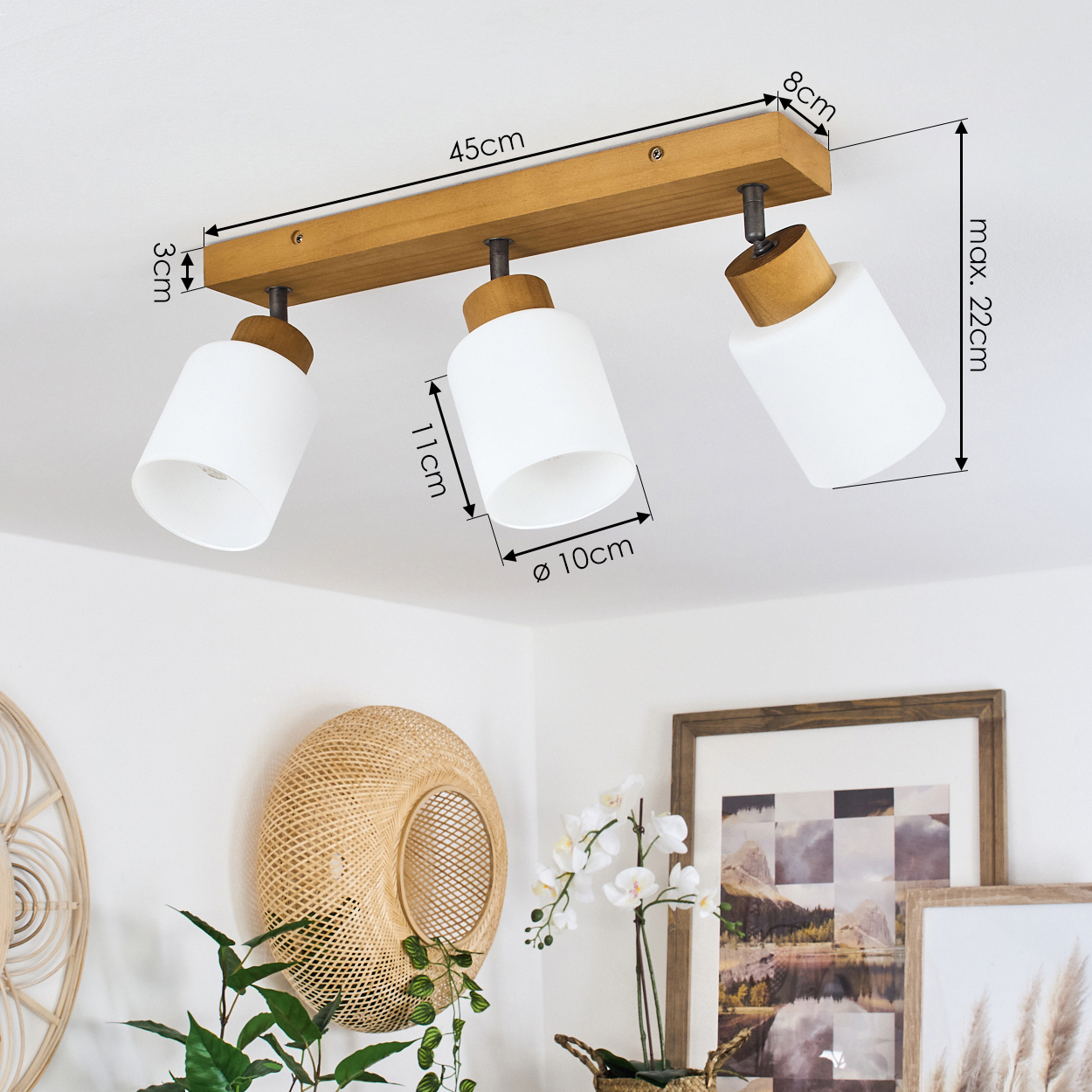 Eine Holzleiste mit drei weißen zylindrischen Lampen, Maße sind angegeben.