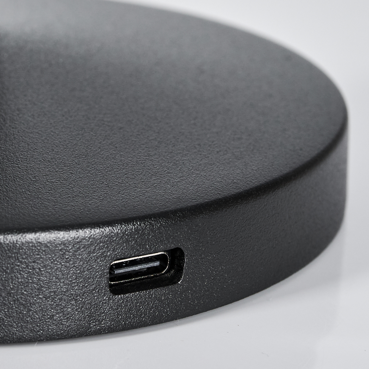 Nahaufnahme einer schwarzen runden Basis mit einem USB-C-Anschluss.