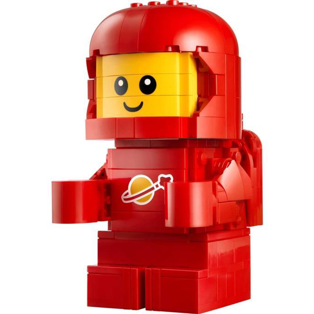 Un astronauta Lego rosso con viso giallo e simbolo di Saturno sul petto.