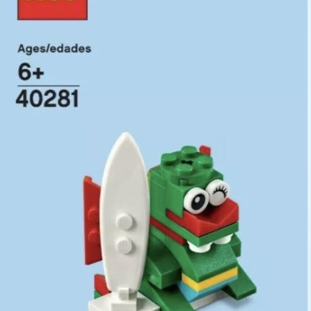 Beyaz sörf tahtası ve kırmızı yüzgeci olan yeşil Lego ejderhası.