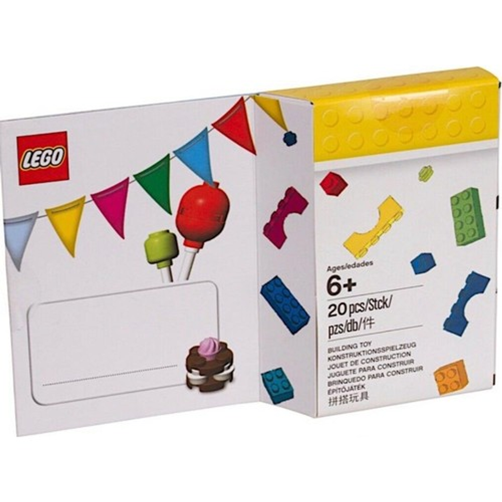 Renkli flama, figür başları ve yapım parçaları olan Lego kutusu. 6 yaş ve üzeri.