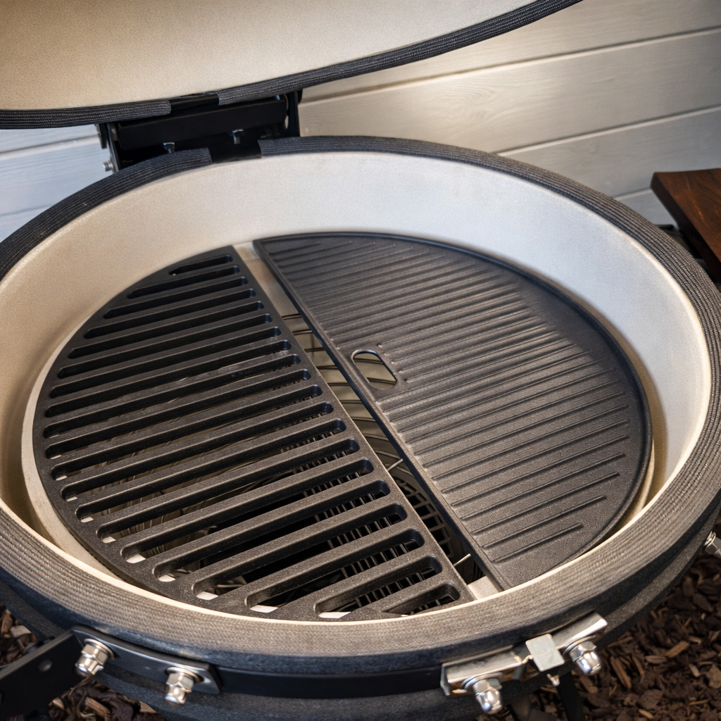 A ceramic grill with two halves of a grate and a plate.