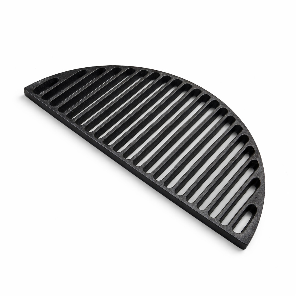 A black, half-circle cast iron grill grate lies on a white background.