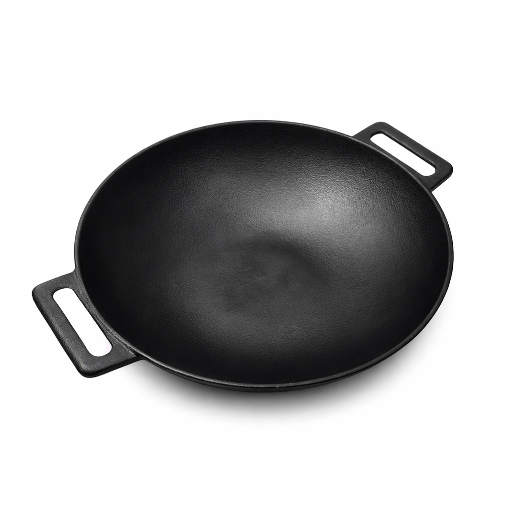 A black cast iron wok pan with two handles on a white background.