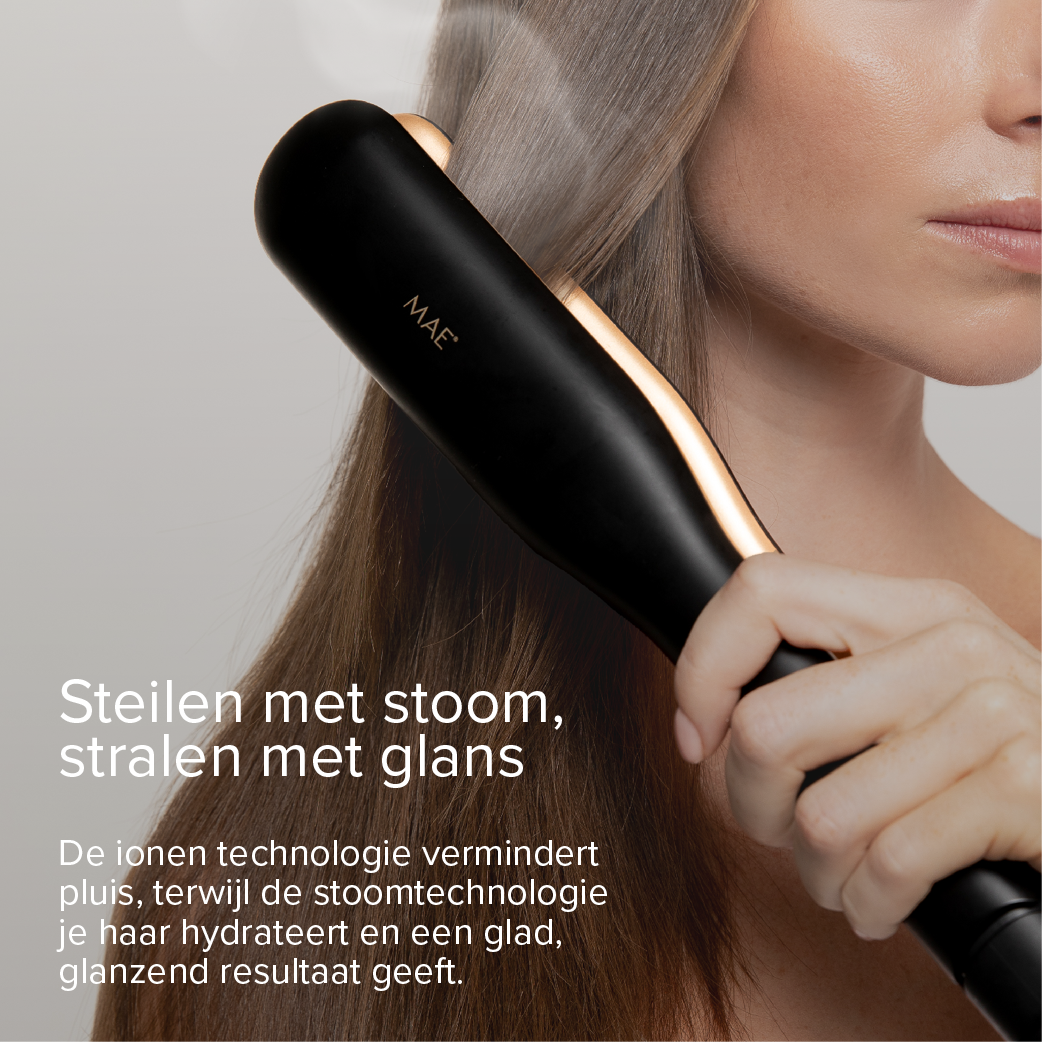 A woman straightens her hair with a black steam straightener with gold accents.