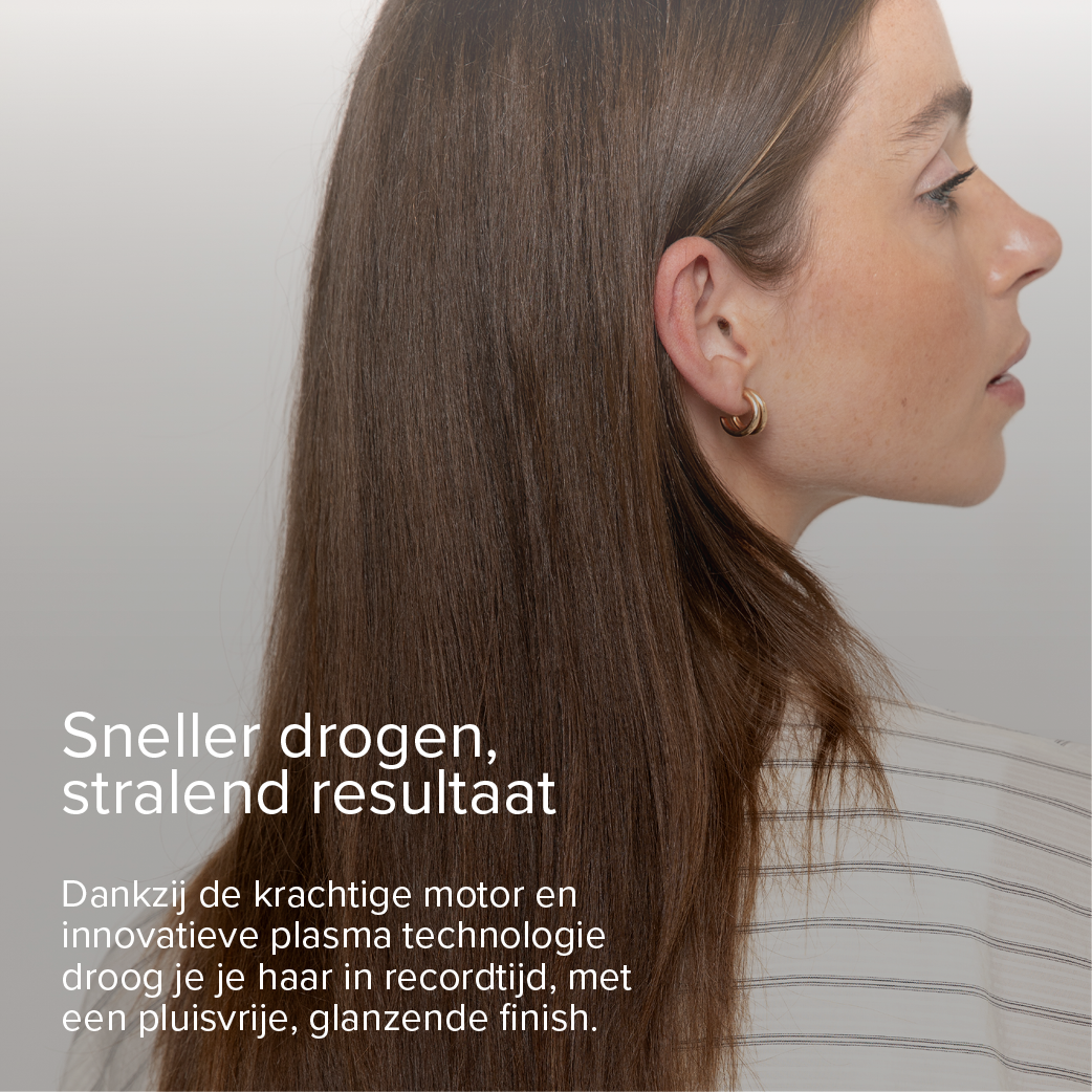 Profile of a woman with long brown hair and gold hoop earrings.