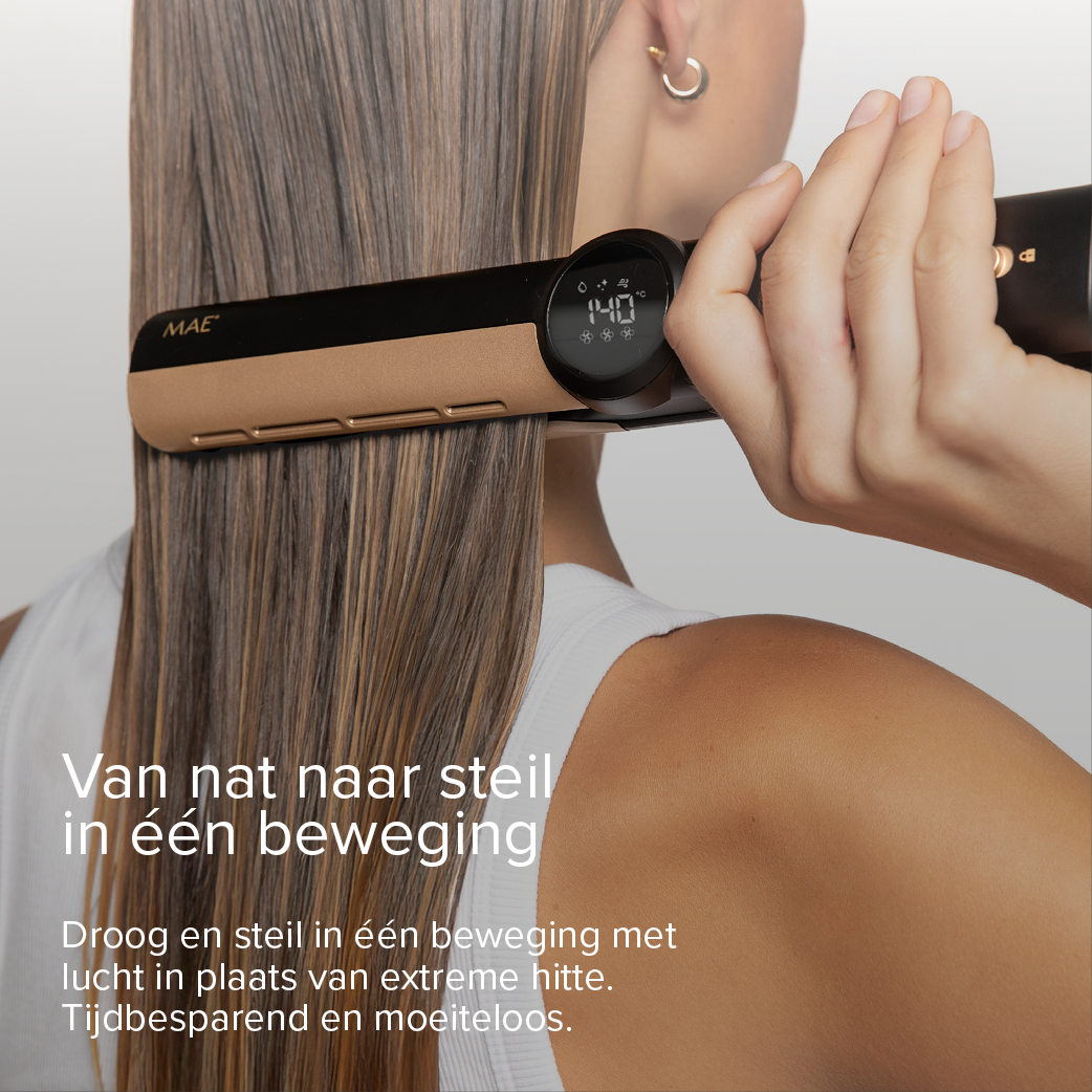 A woman straightens her hair with a gold and black straightener. The temperature is set to 140°C.