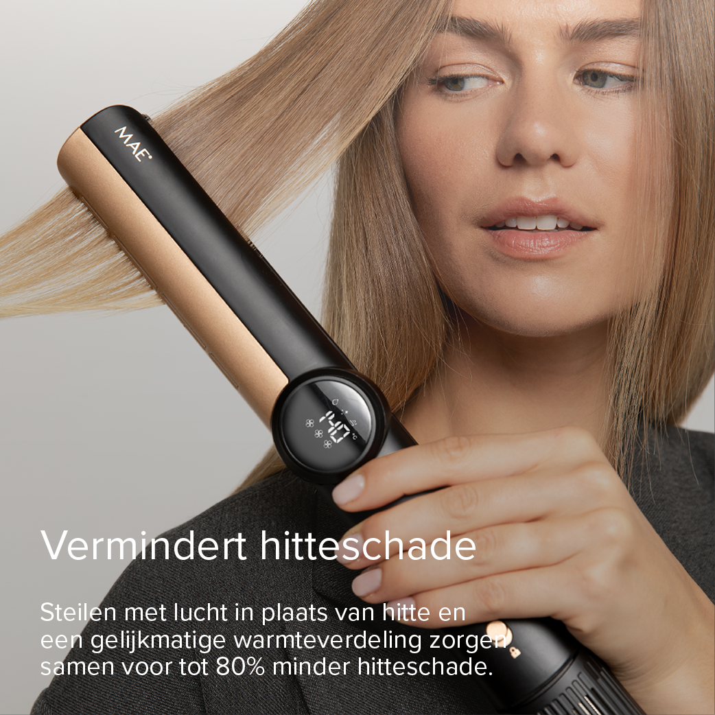 A woman straightens her blonde hair with a black and gold hair straightener.