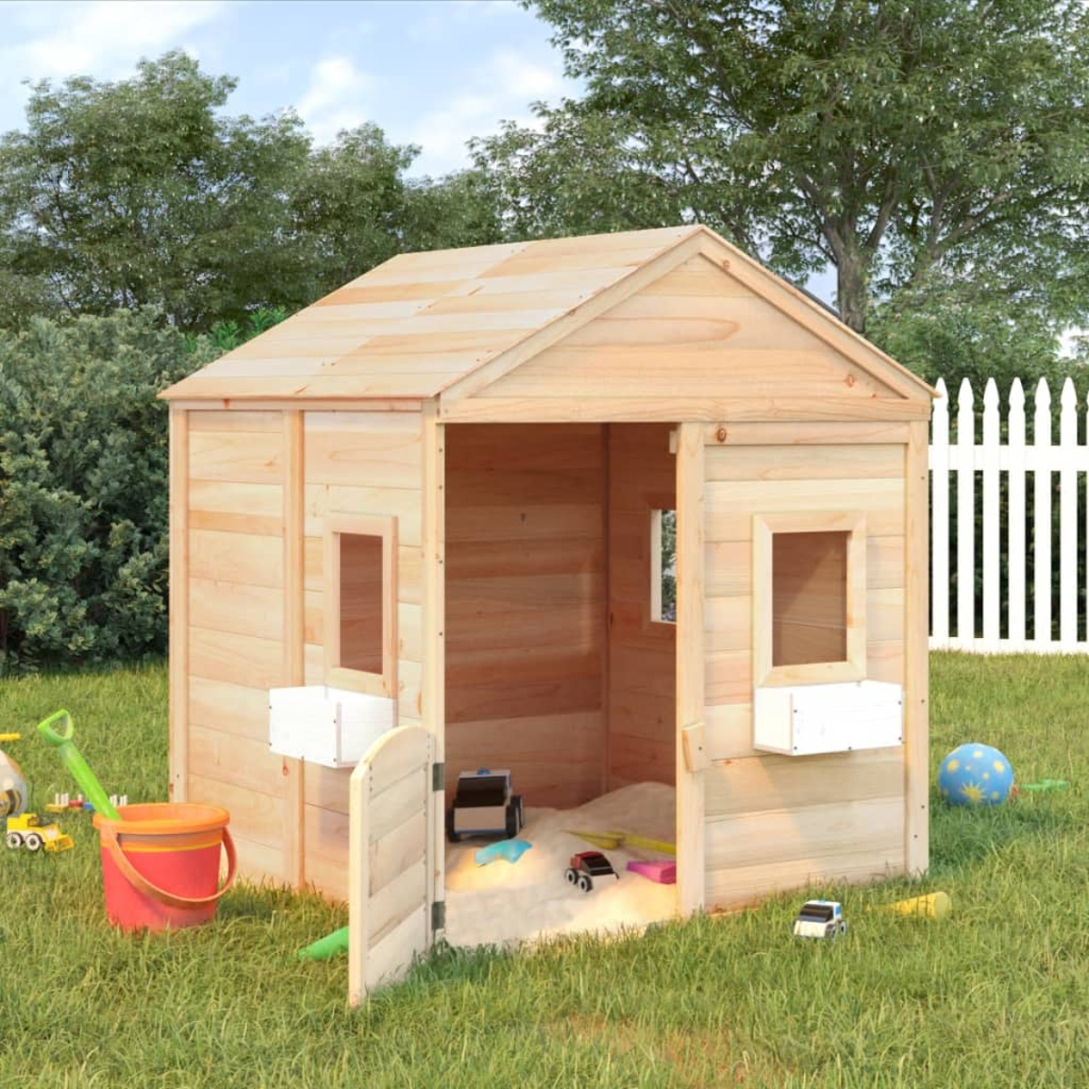 Una casa giochi in legno con porta aperta, sandbox e giocattoli su prato.