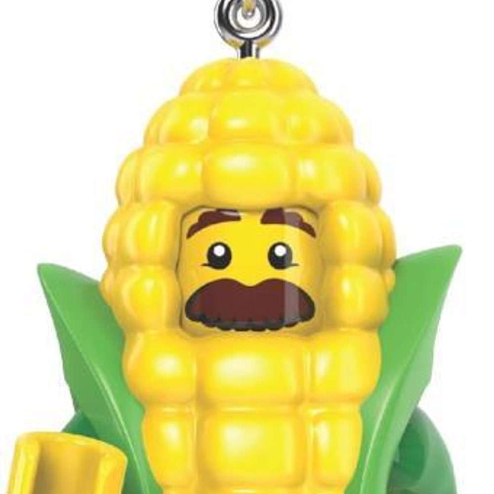 Kahverengi bıyıklı ve yeşil yapraklı sarı Lego mısır koçanı figürü.