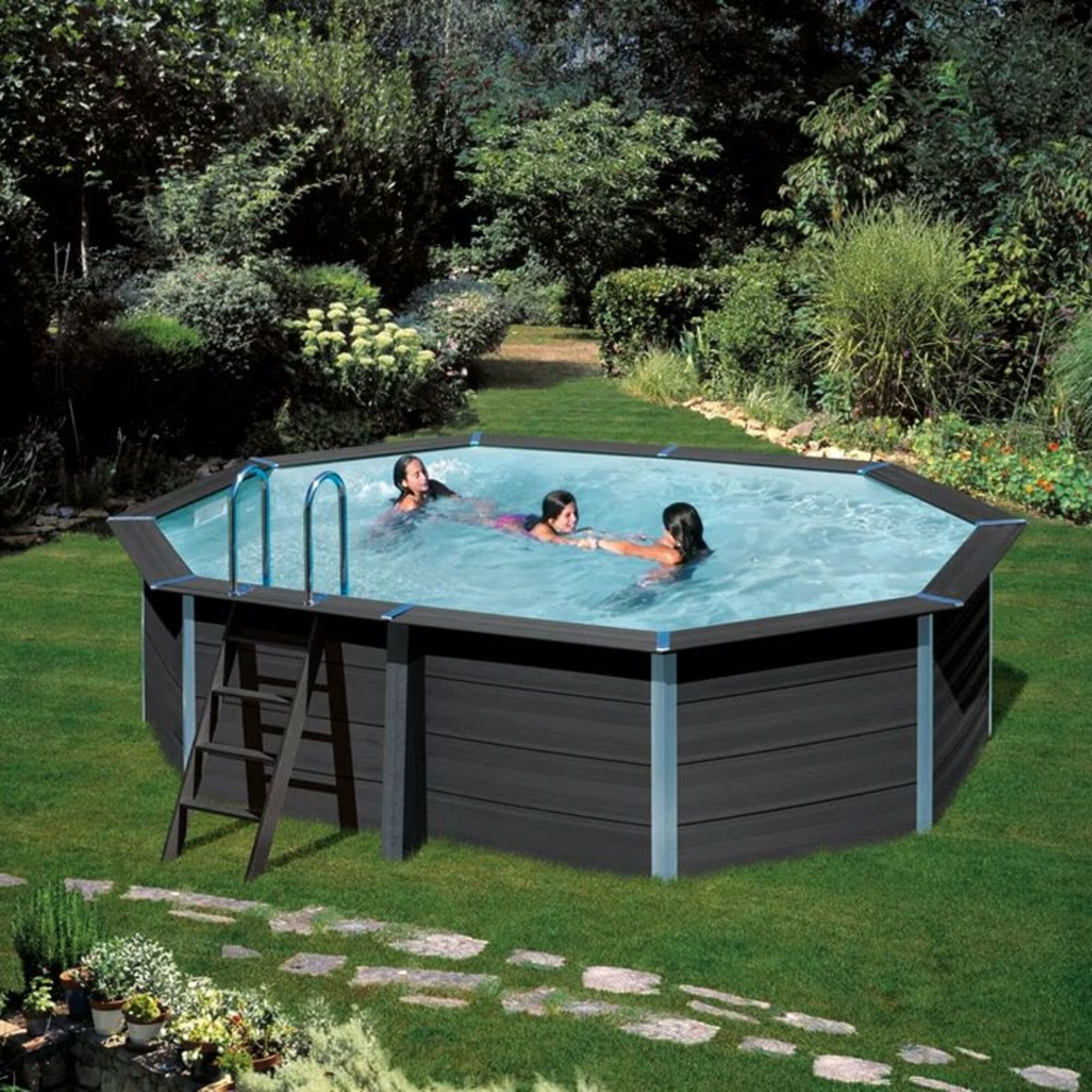 Tres niños chapotean en una piscina octogonal al aire libre.