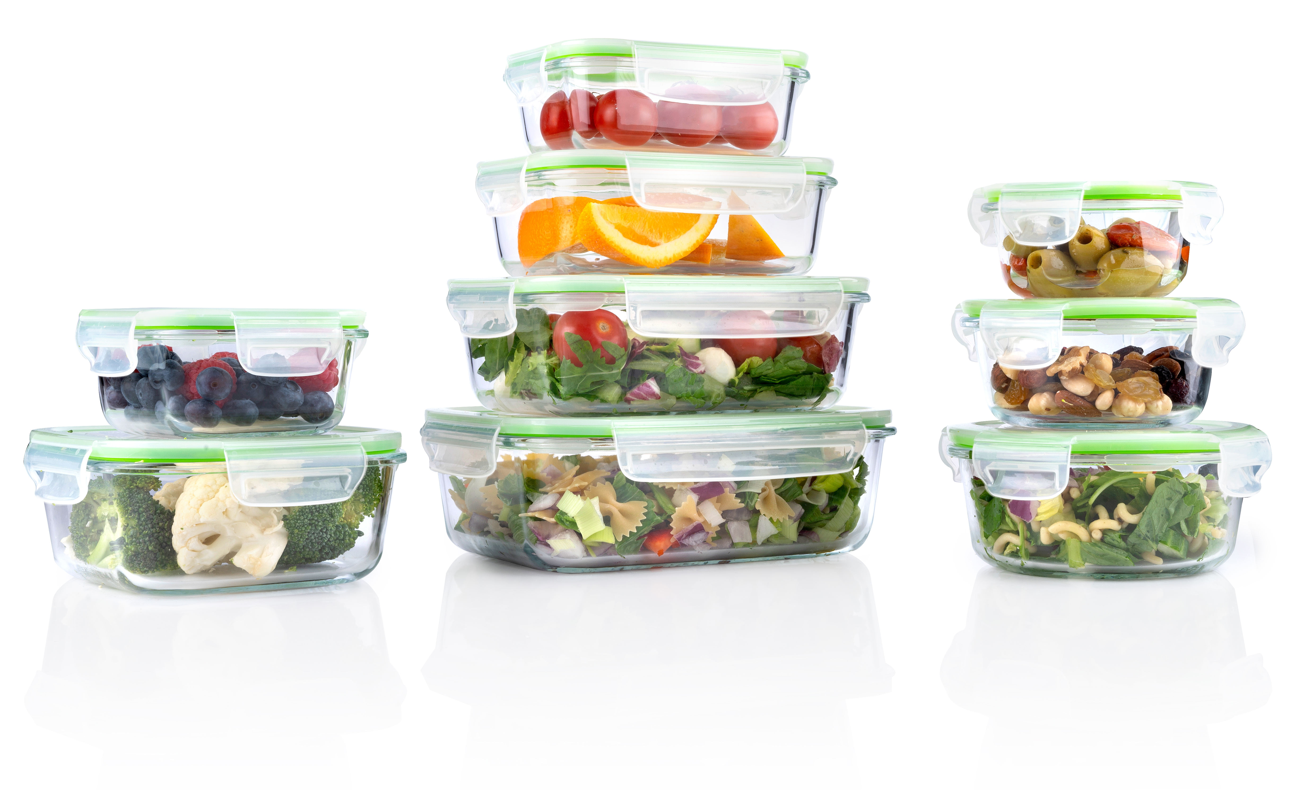 Stacked glass containers with various foods like berries, oranges, vegetables, and pasta.