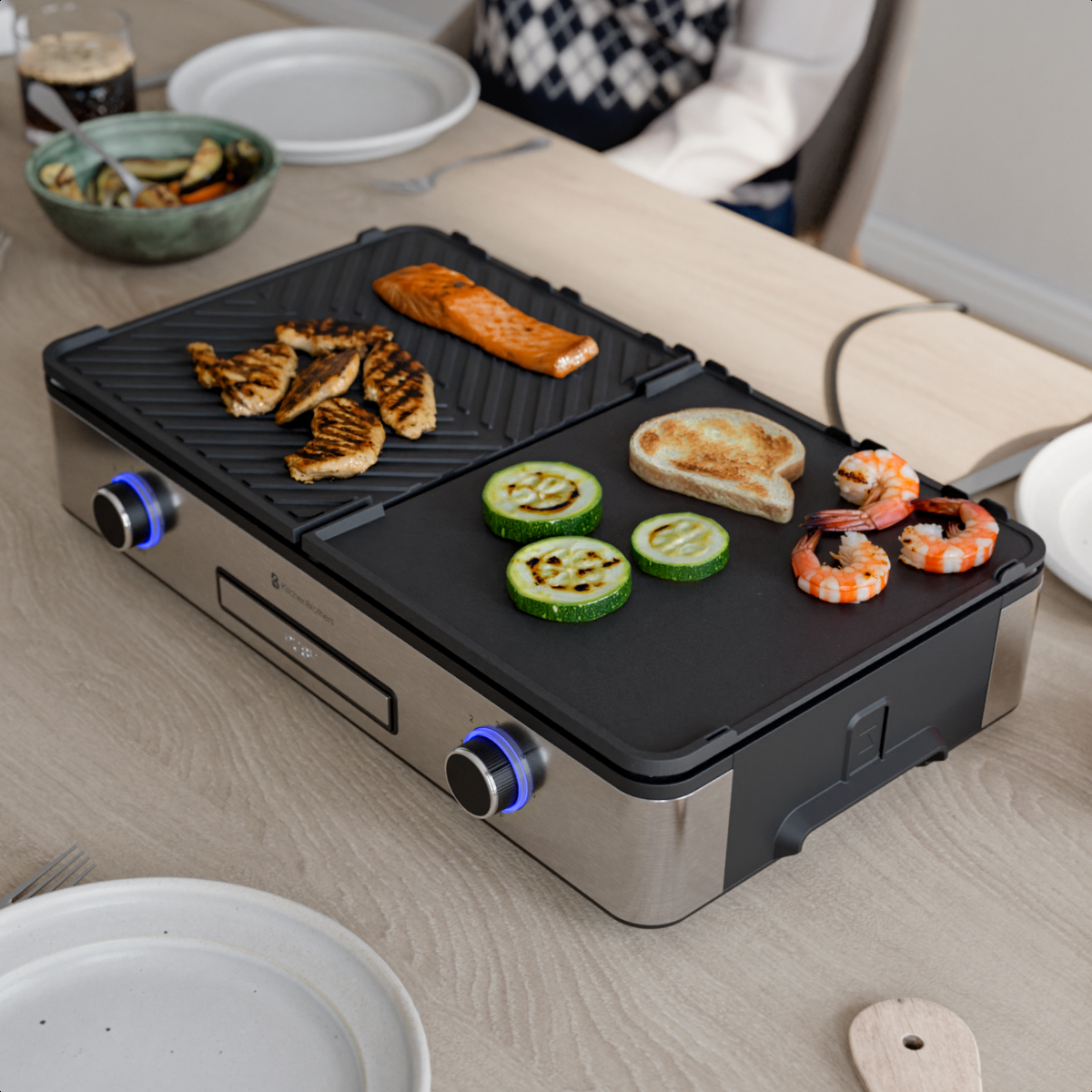 An electric grill with chicken, salmon, zucchini, bread, and shrimp.
